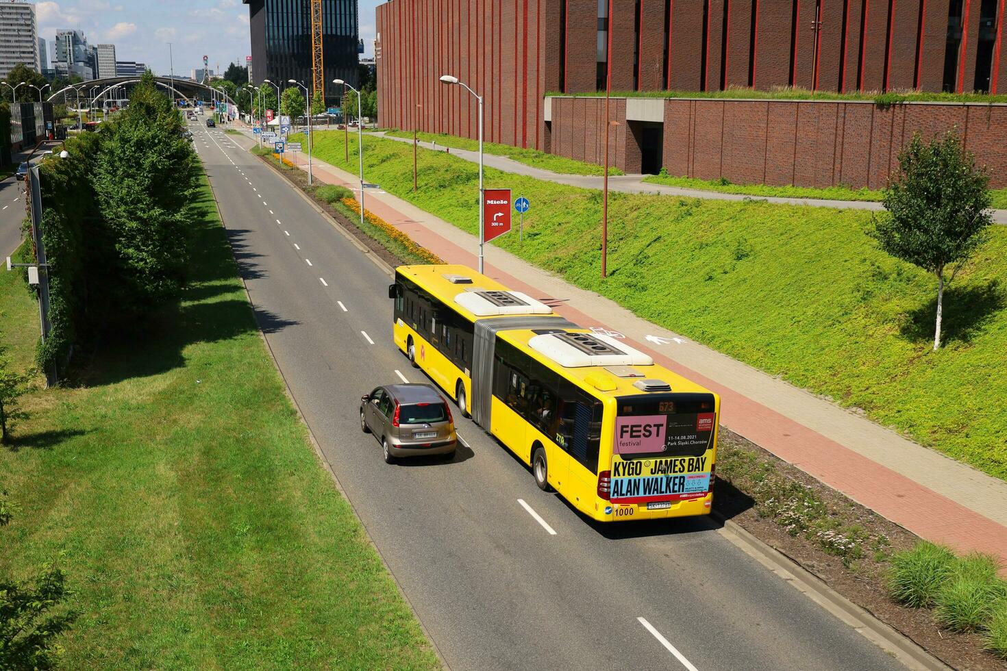 KATOWICE, POLAND, 2021 - Public bus Mercedes O530 Citaro G, line number 673 follows its route in the area Katowice Cultural Zone near NOSPR. Top view from the footbridge over the alley. photo