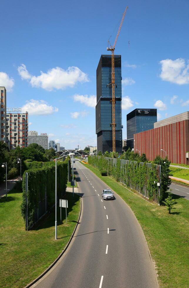 KATOWICE, POLAND, 2021 - View to Walentego Rozdzienskiego Alley on the height of the footbridge. Cityscape, KTW office buildings and Katowice Cultural Zone on the right. Vertical image. photo