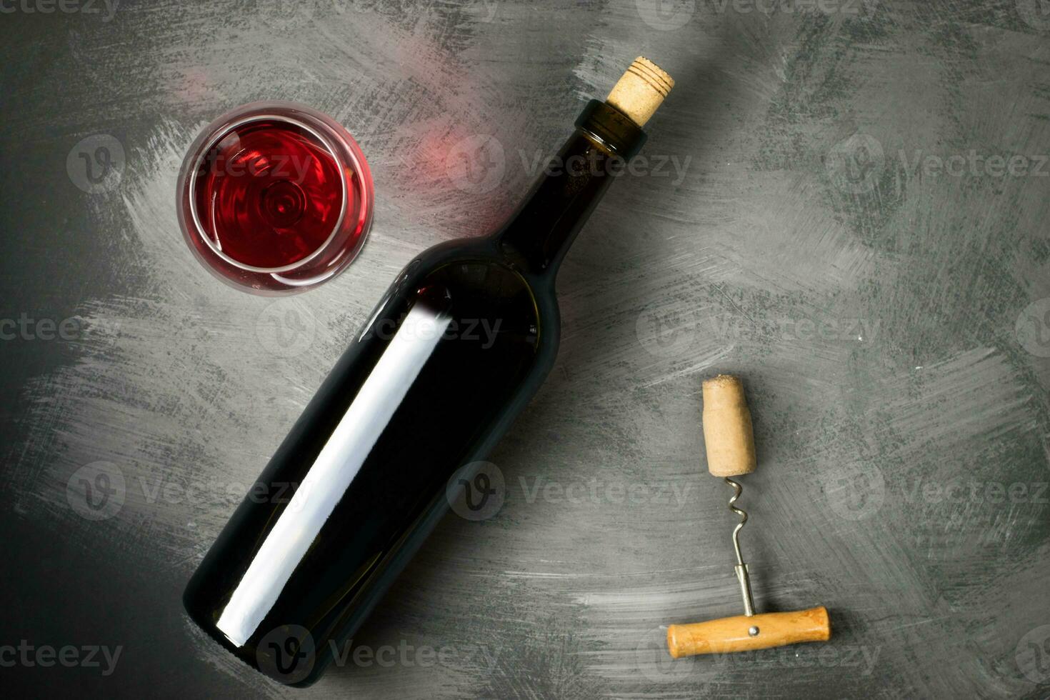 Red wine bottle on a wooden background photo