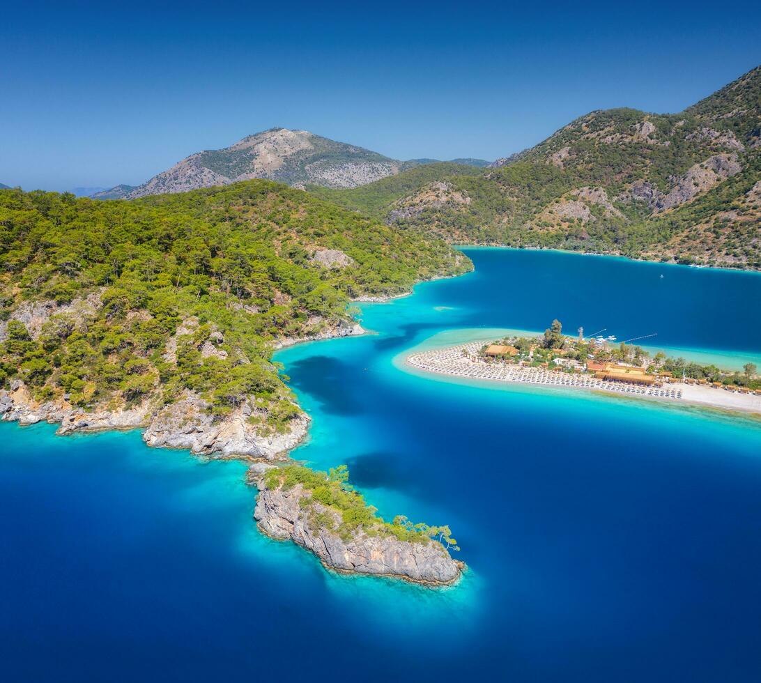 Aerial view of sea bay, rock, sandy beach, trees, mountain photo