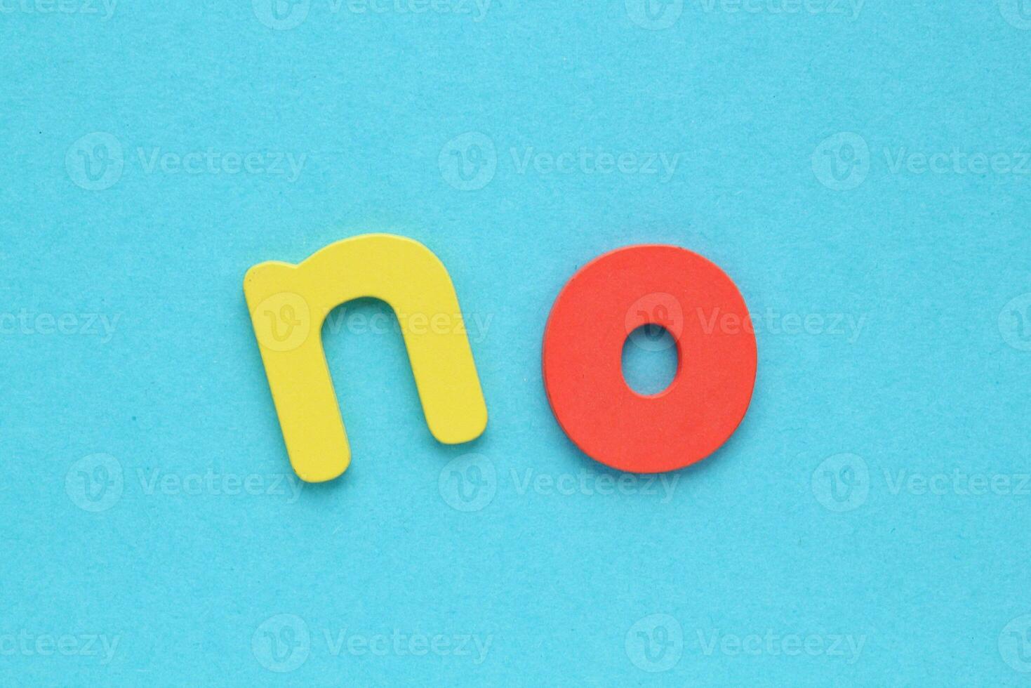 Colorful letters with word No on blue background. Negative answer concept. Decision, disagreement, rejection, refusal or contradiction photo