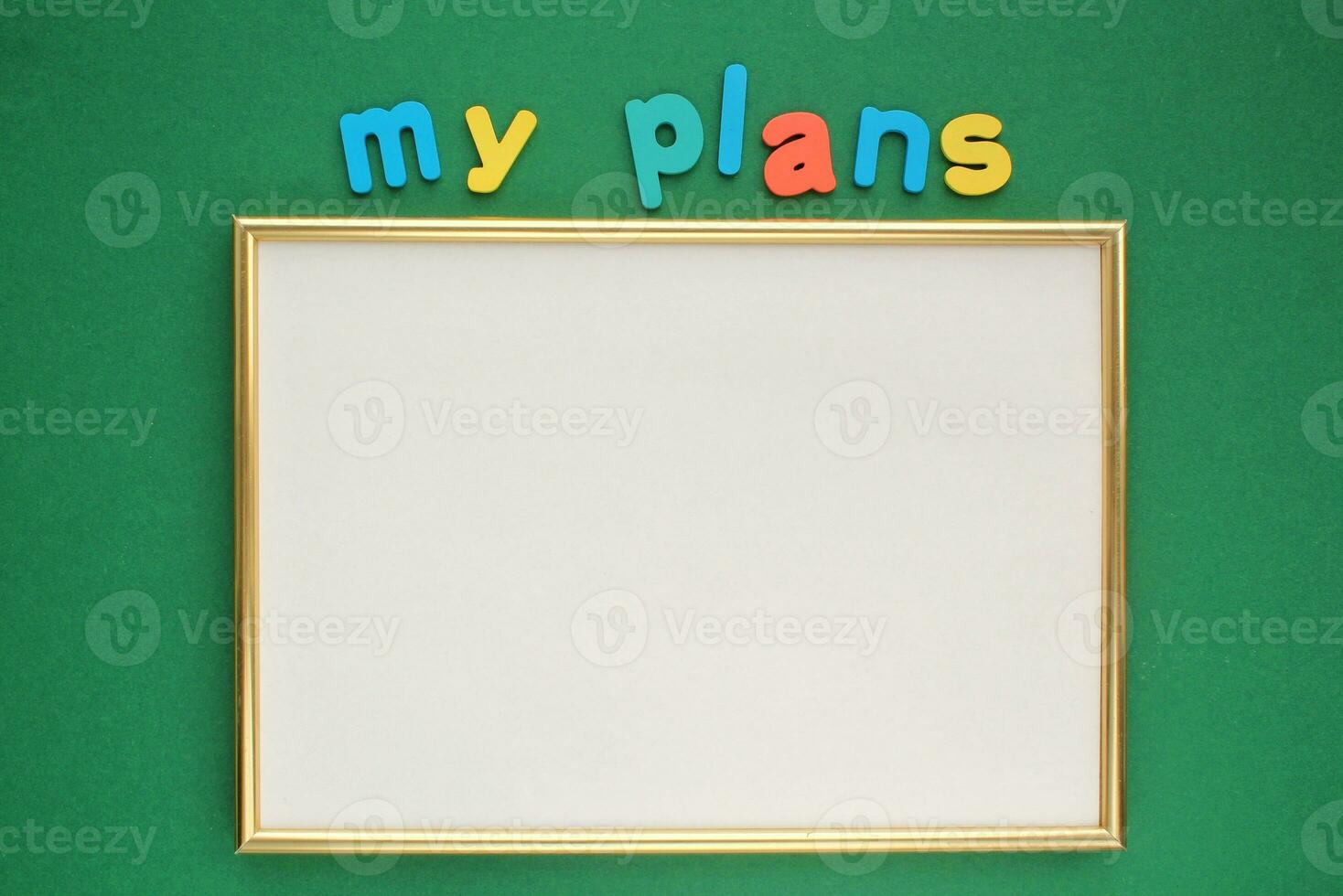 Colorful alphabet word text My plans and blank frame on green background. photo