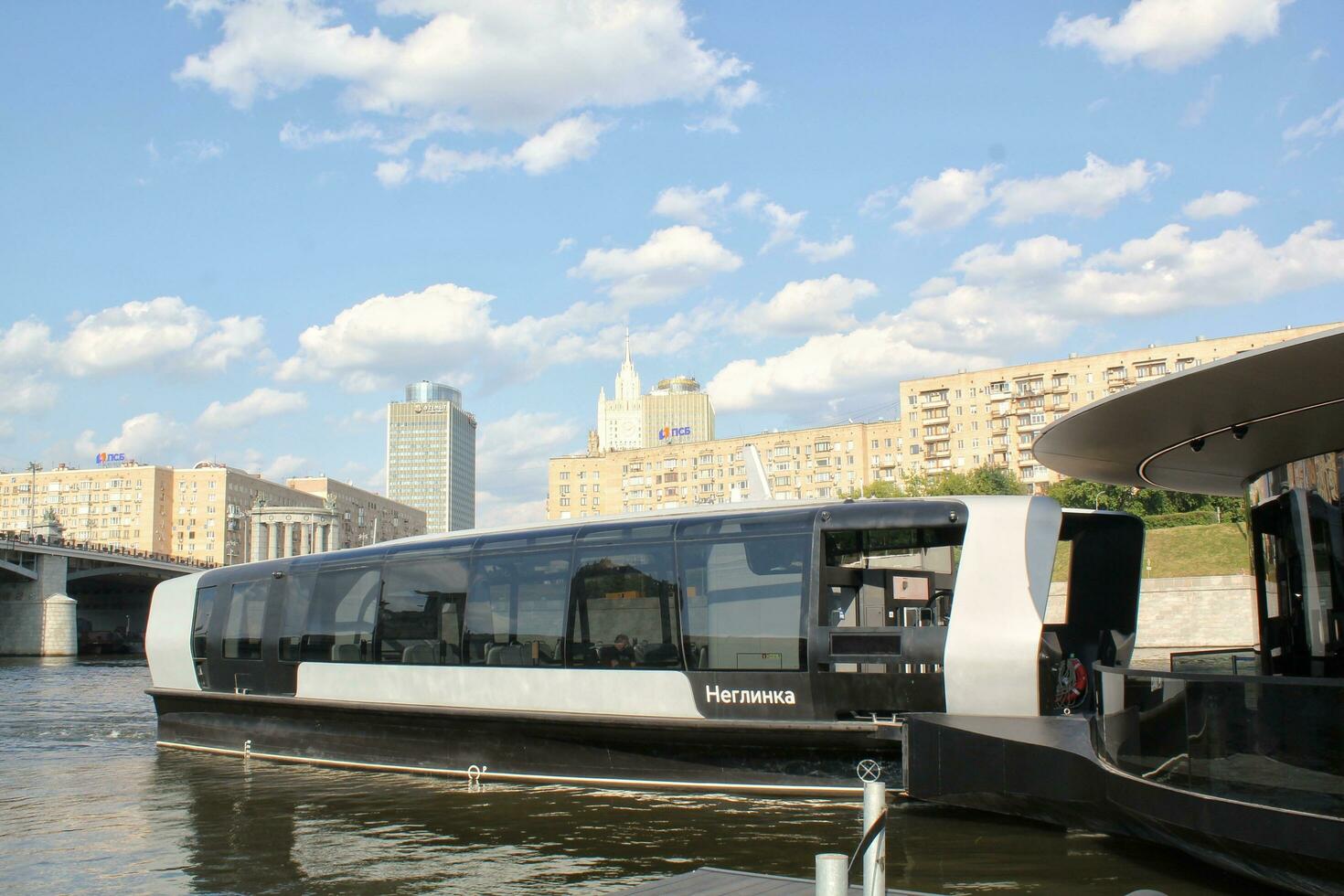 Aquabus boat on Moskva River. Electrical ship at Moscow public transport. Ecological technology. Green energy in city route. Daily passenger ferry service. Moscow, Russia - June 22, 2023. photo