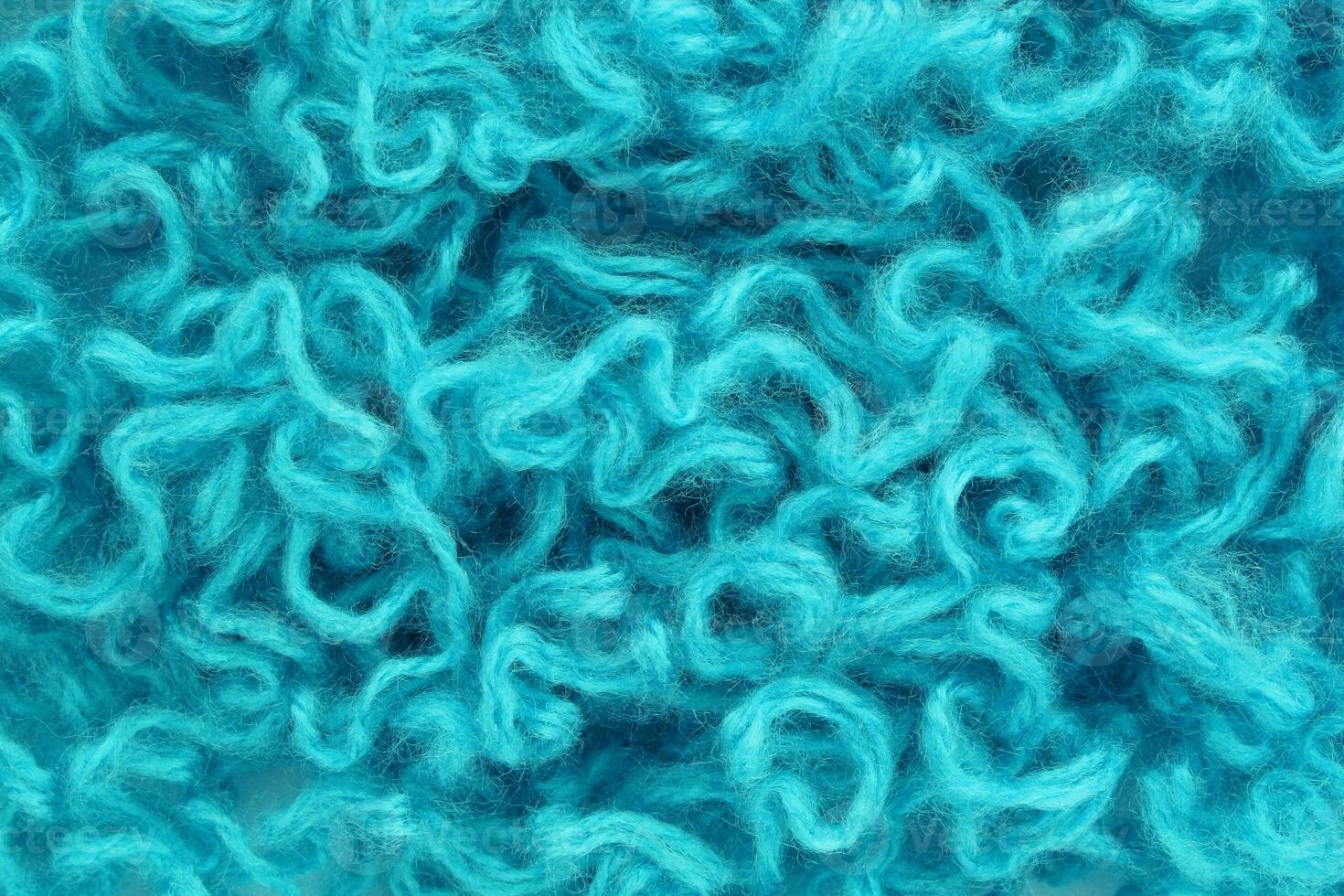 Close-up of colourful merino wool deep blue striped background. Abstract handmade craft knitting yarn textured pattern flatlay. Holiday christmas concept. Idea for felting, needlework, hobby. Mock up photo
