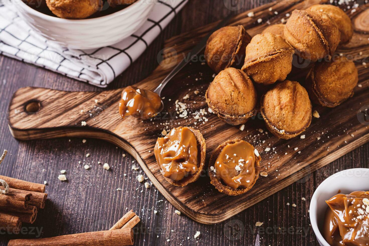 Fresh nut shaped cookies filled with boiled condensed milk on a board photo