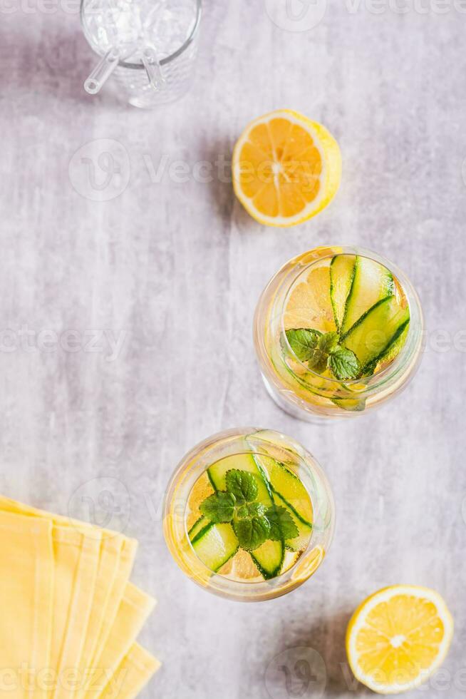 Hugo spritz sparkling cocktail with champagne, cucumber, lemon and mint in glasses top and vertical photo