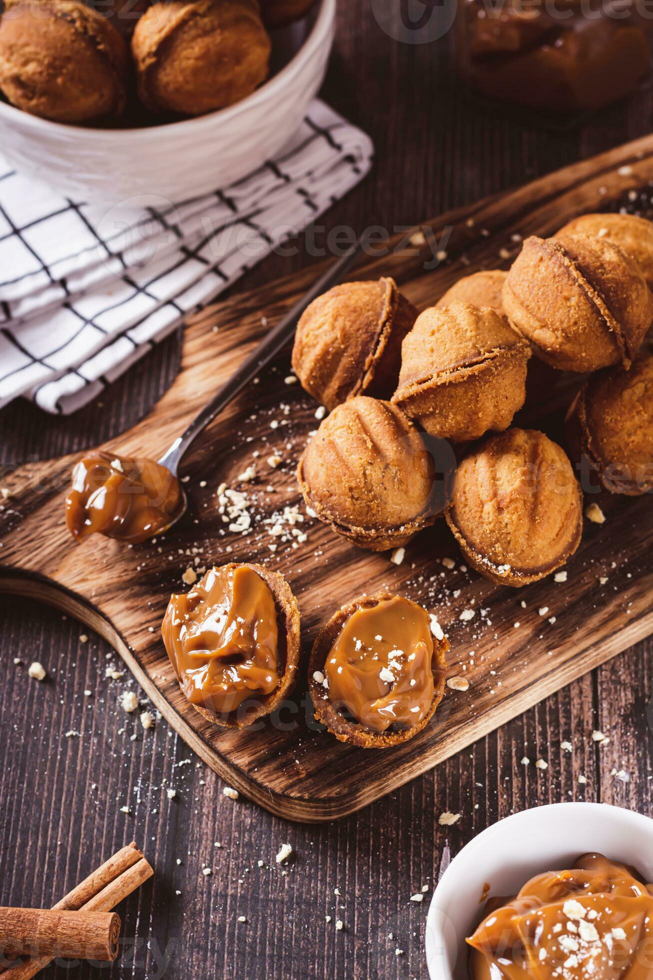 Fresh nut shaped cookies filled with boiled condensed milk on a board