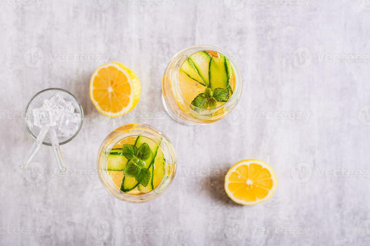Summer hugo spritz cocktail with champagne, cucumber, lemon and mint in wine glasses top view photo