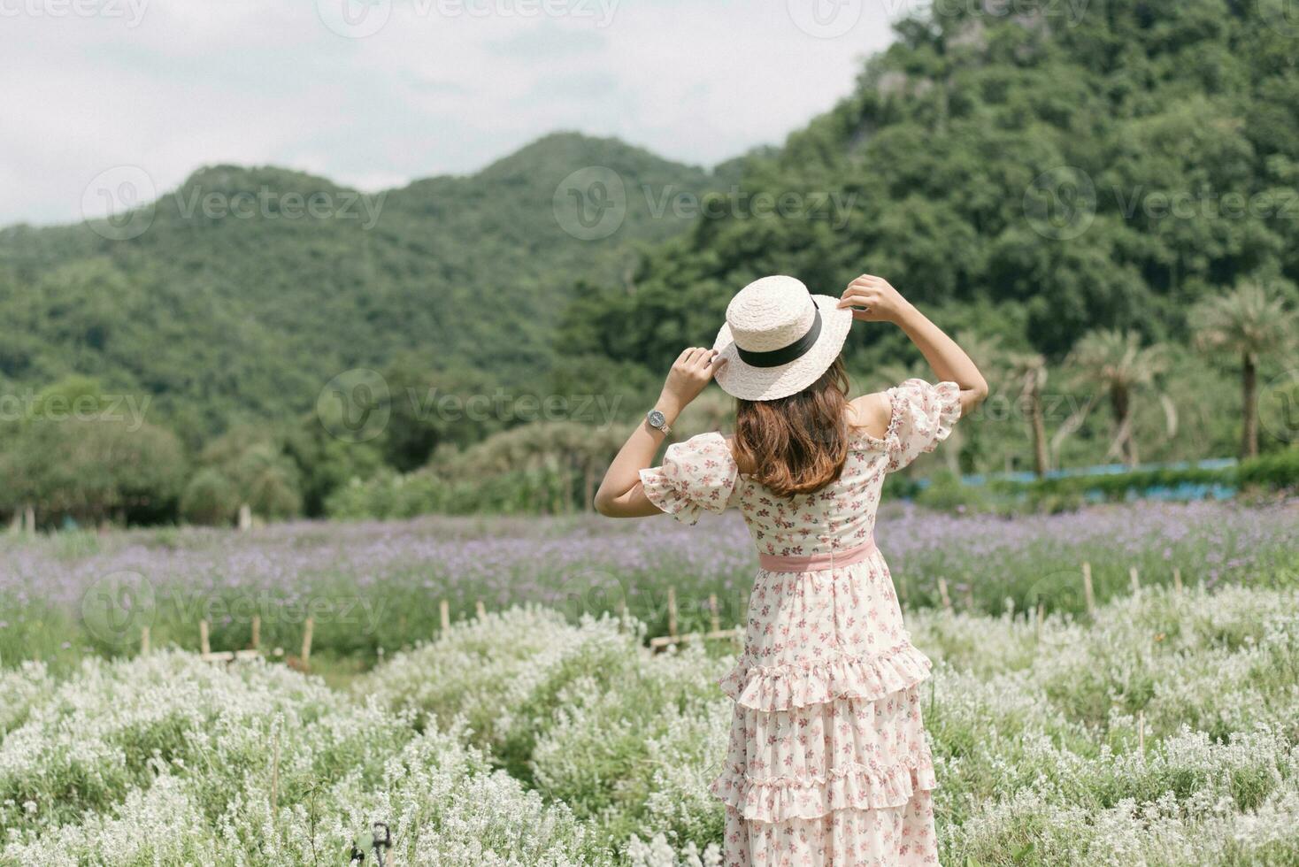 mujer joven con ramo en campo de lavanda foto