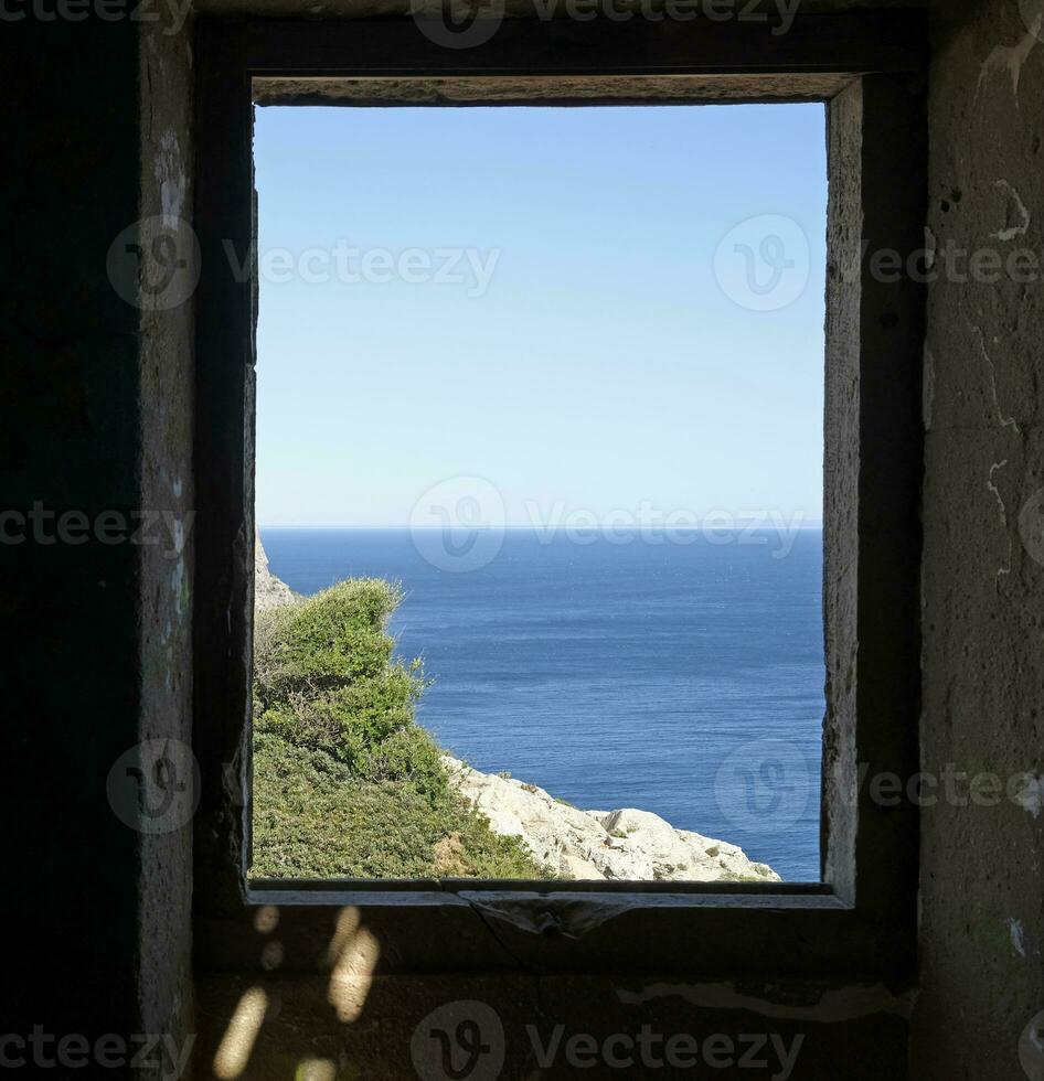Ocean view from an abandoned building at the coast of Portugal photo