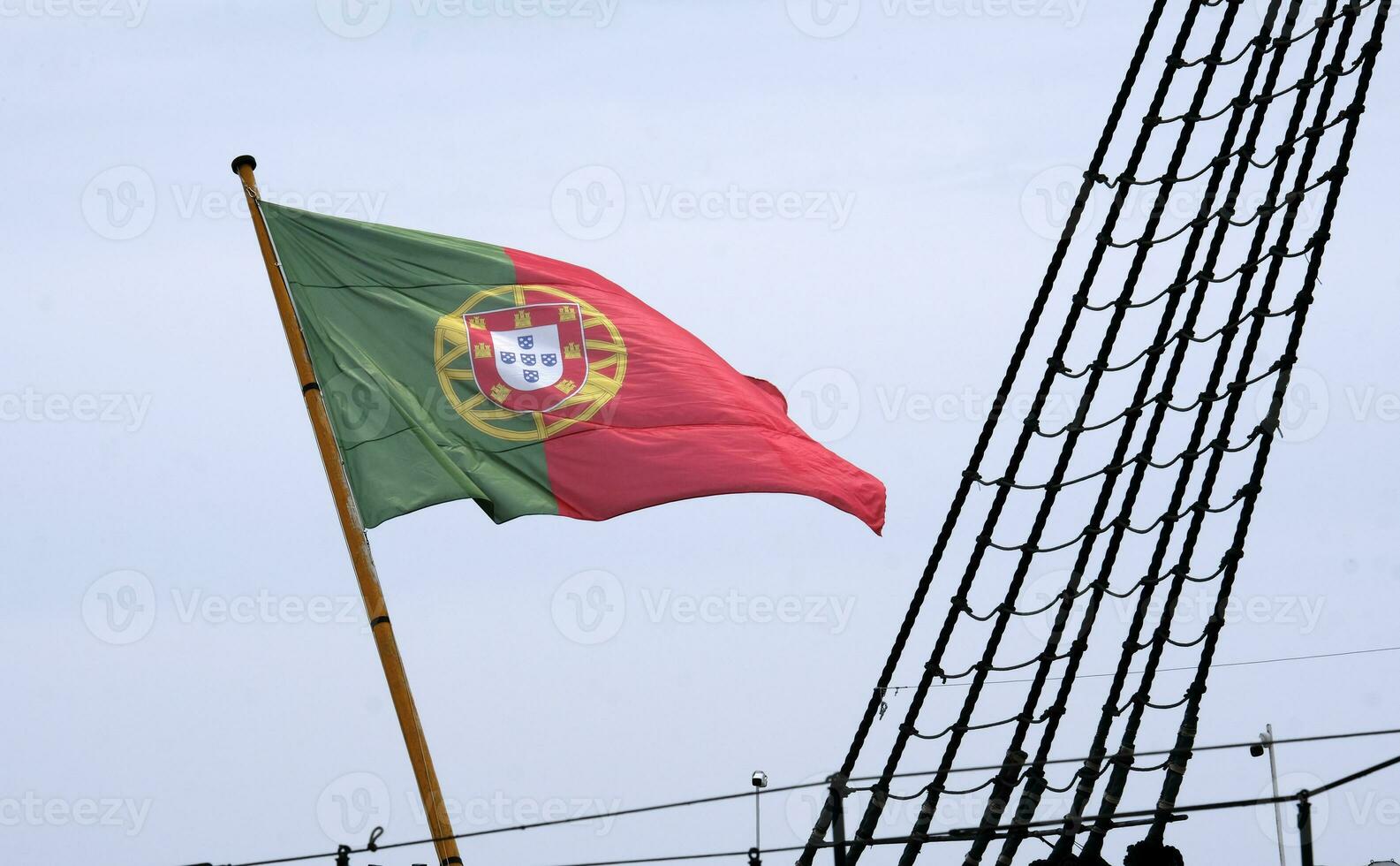 Portuguese flag waving in the wind on a ship in Lisbon photo