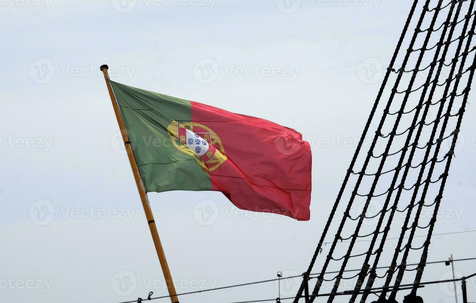 Portuguese flag waving in the wind on a ship in Lisbon photo