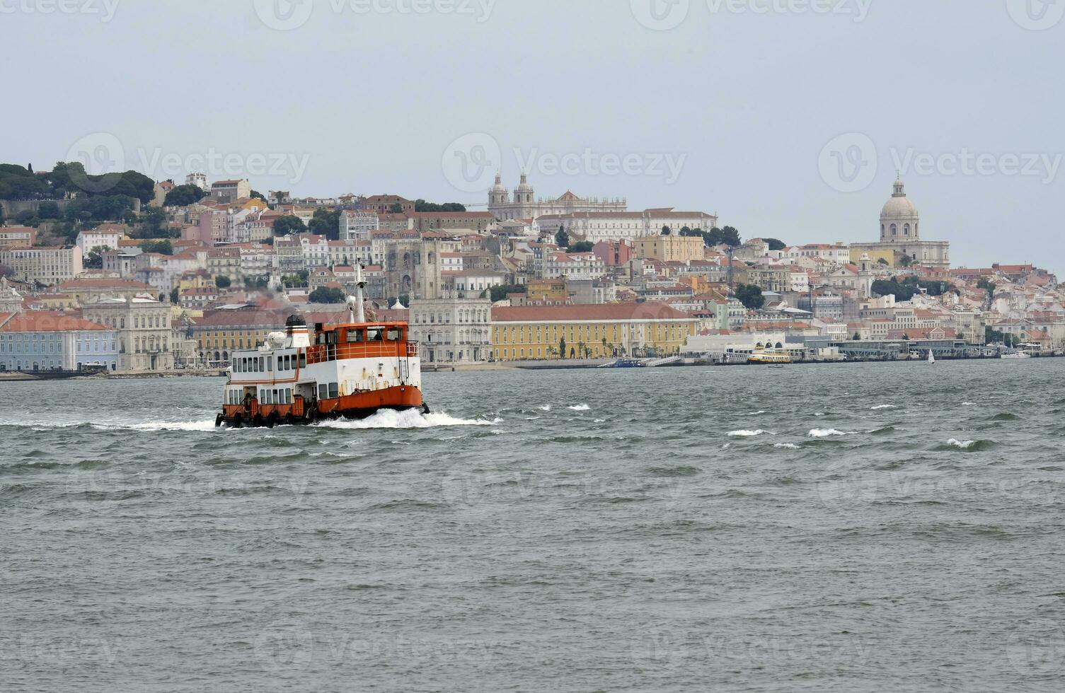 Old ferry crossing the water in Lisbon, Portugal photo