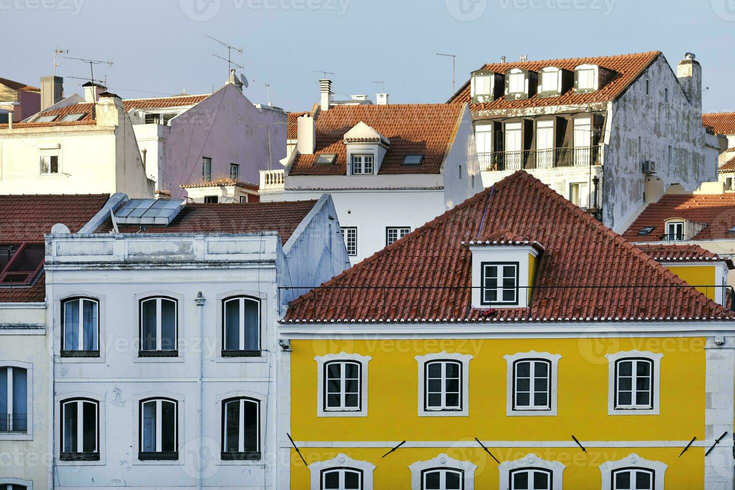 Buildings and roof tops in Lisbon in the afternon hours with clear sky photo