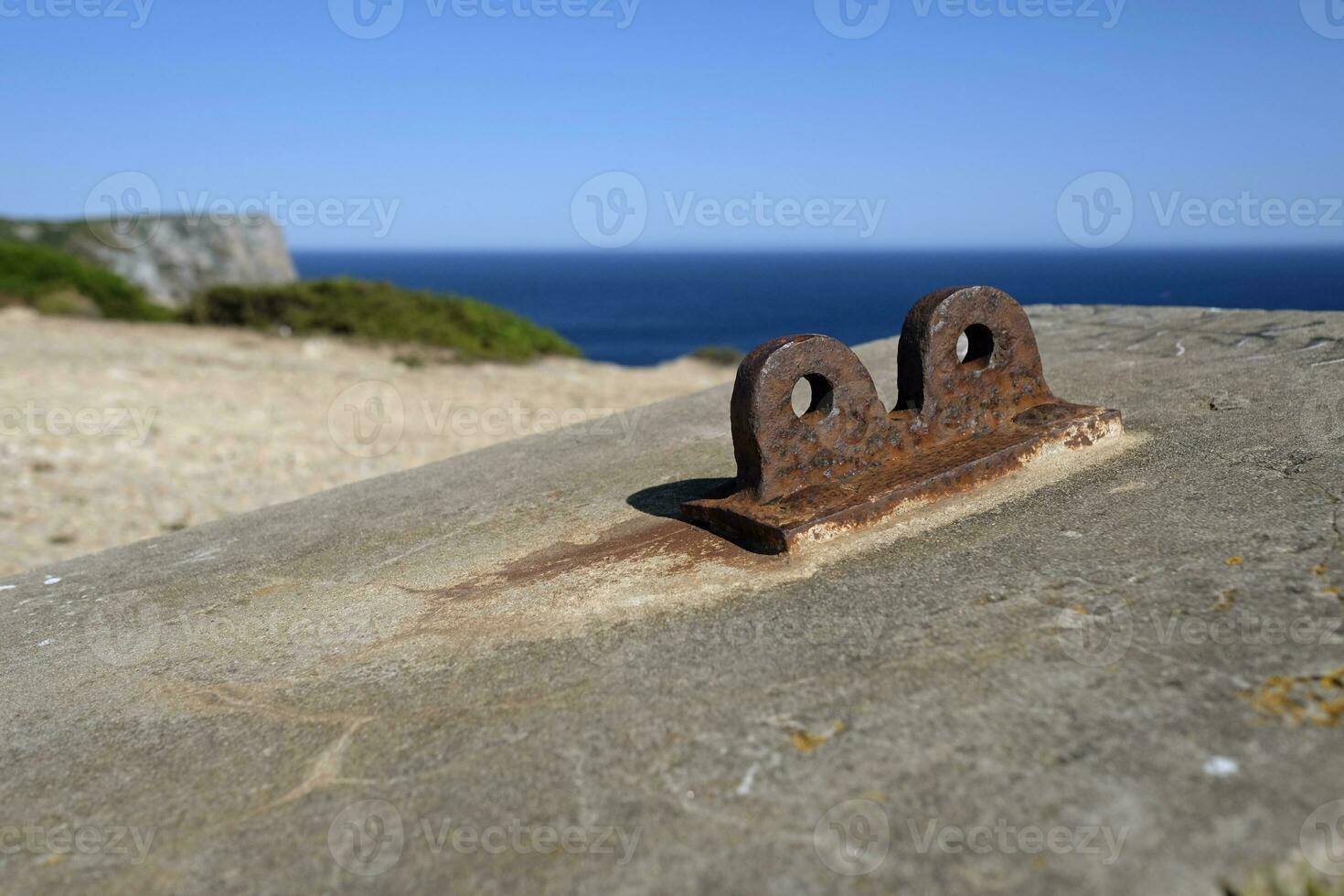 Rusty metal mount near an abandoned coastal building in Portugal photo