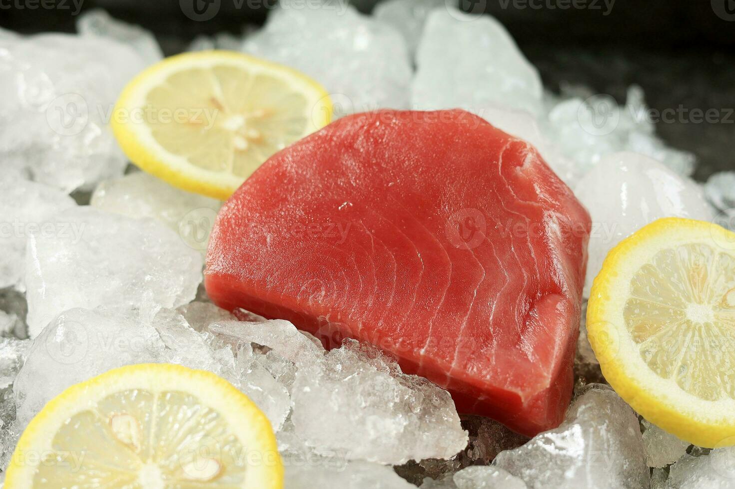 Fresh Raw Tuna Steak with Lemon and Ice. photo