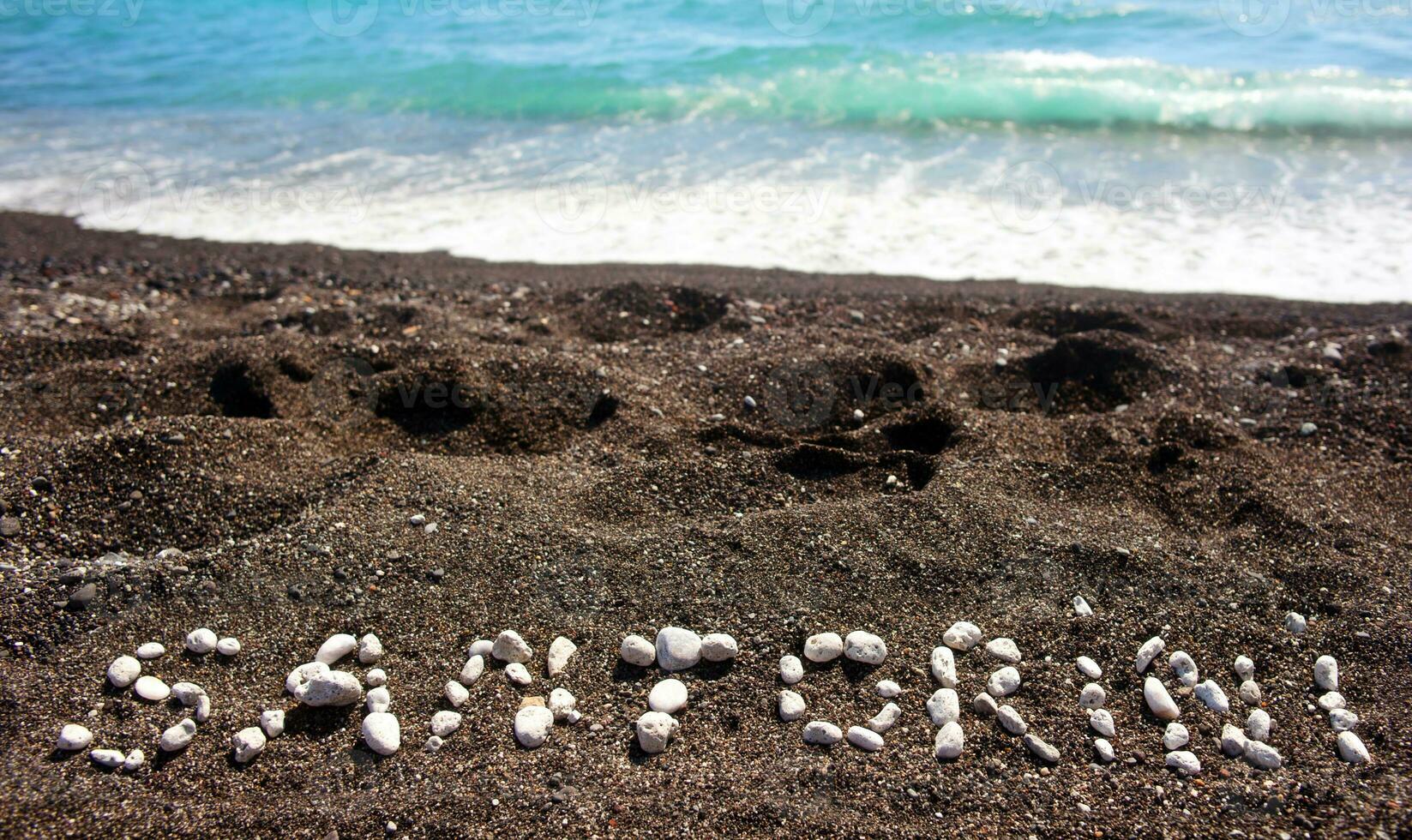 Santorini text on wthe beach photo