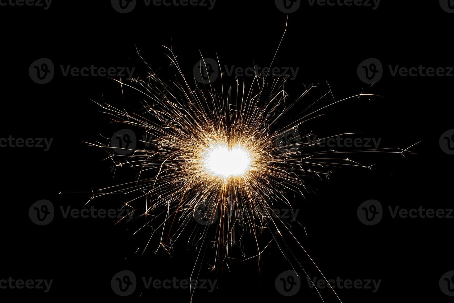 Burning sparkler isolated on black background. Fireworks theme. Light effect and texture. photo