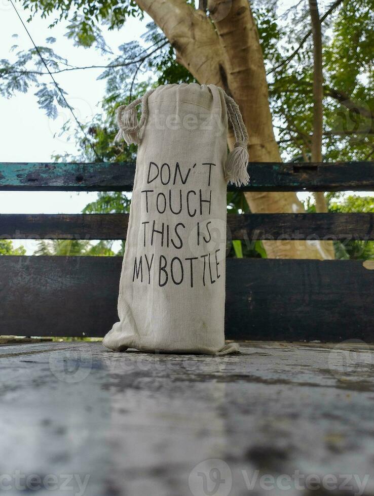 a bottle of water with the message don't touch this is my bottle photo