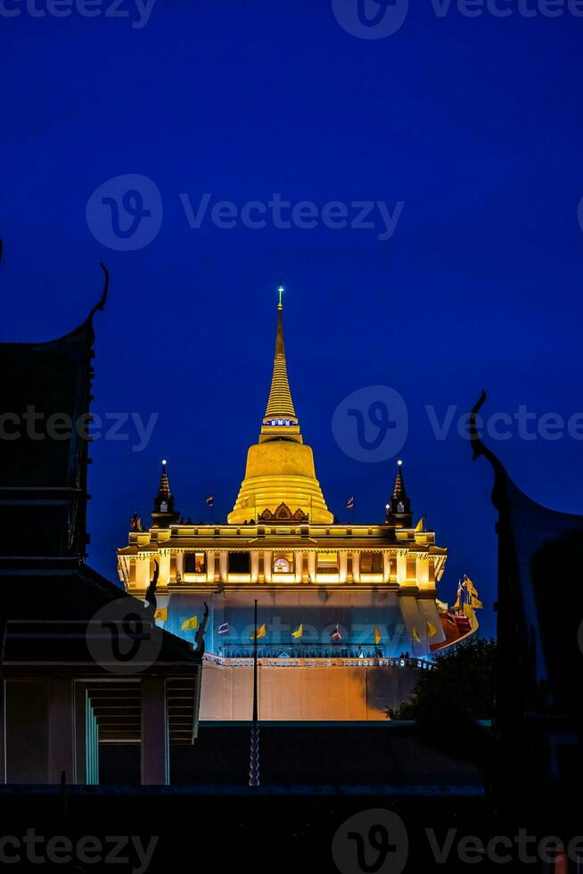 Beautiful sunset at Golden mountain phu khao thong an ancient pagoda at Wat Saket temple on January 29, 2023. The famous destination in Bangkok, Thailand. photo