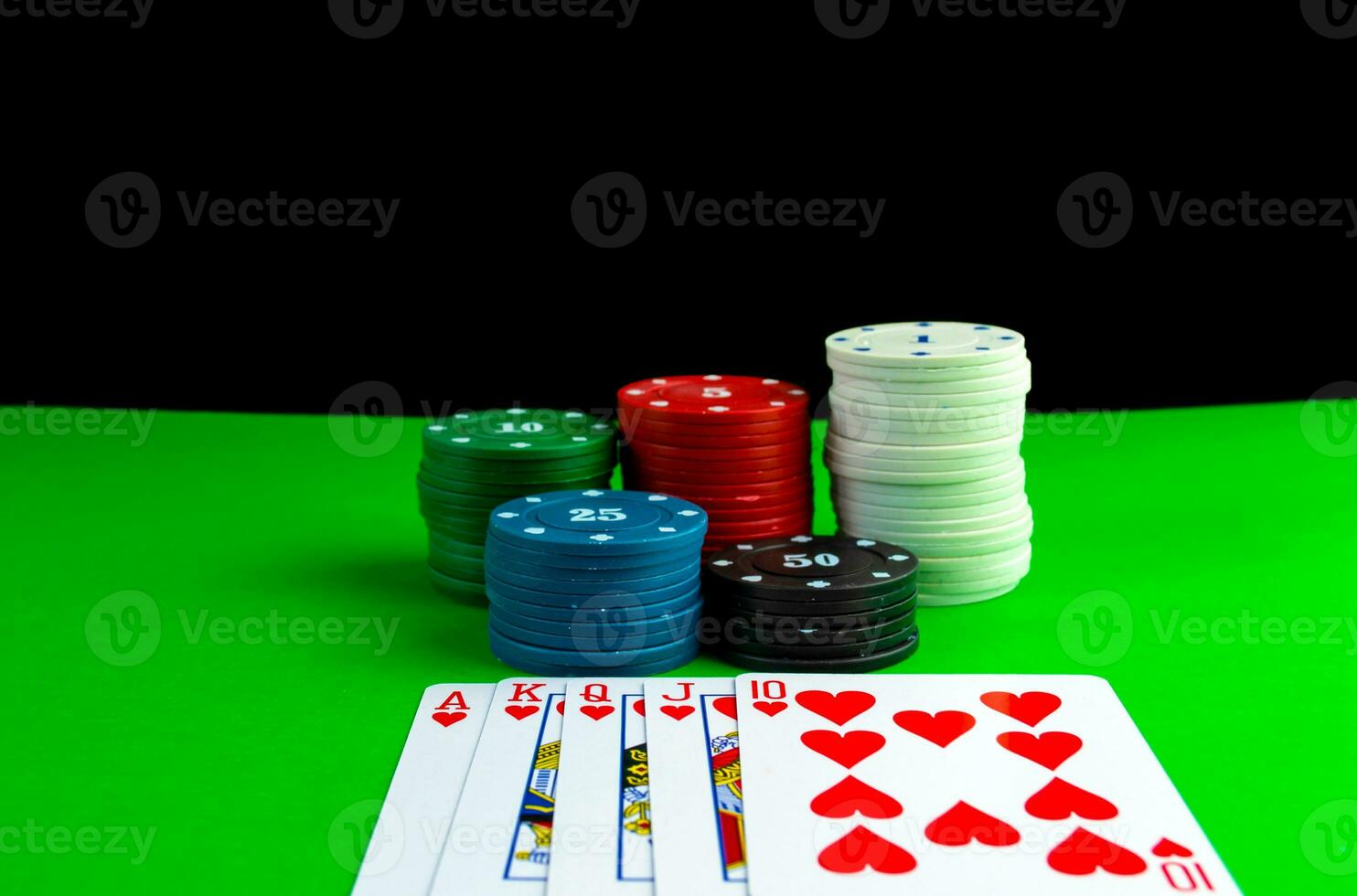 Poker chips in stacks and royal flush cards on the poker table. photo