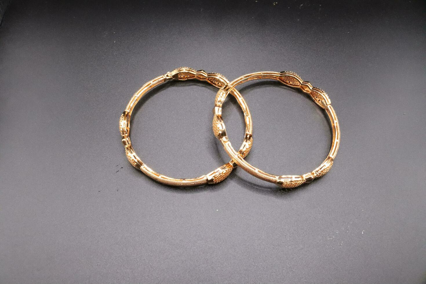 Women gold bangles with black background,bangles design photo