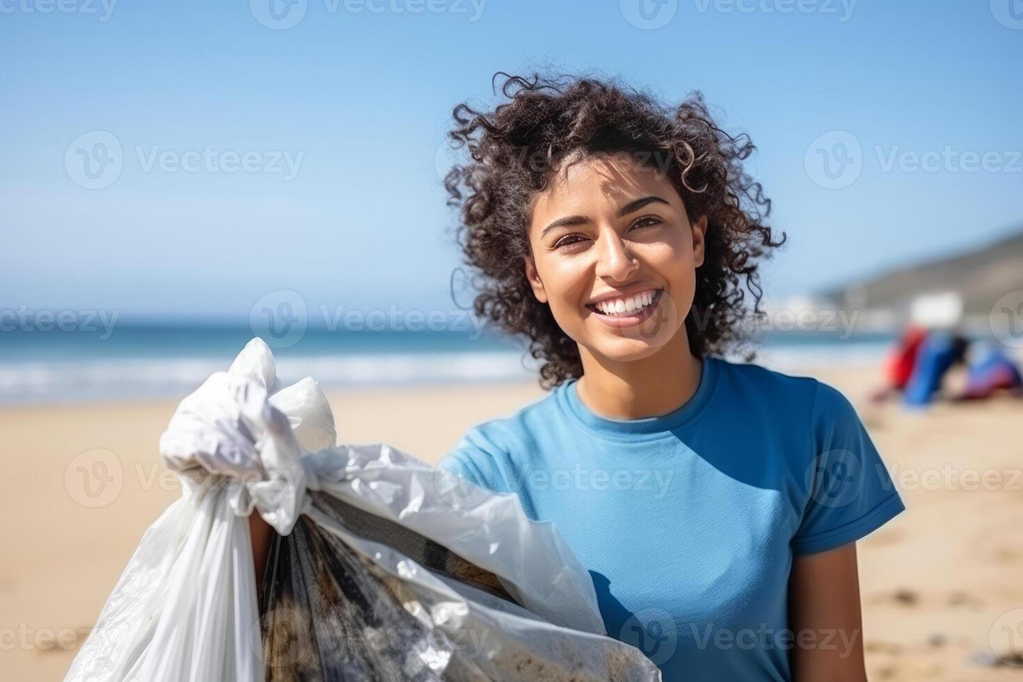portrait close up smiling mixed race volunteer woman collecting trash on the beach, blue ocean and sky background. photo