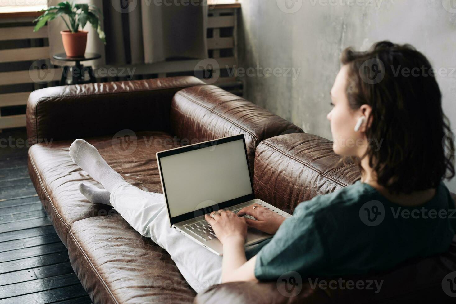 Modern Work and Connectivity, Young Woman Utilizing Laptop with Blank Screen at Home, Showcasing Versatility of Freelancing, Student Life, Online Education, Web Conferencing, Video Calls, Technology photo