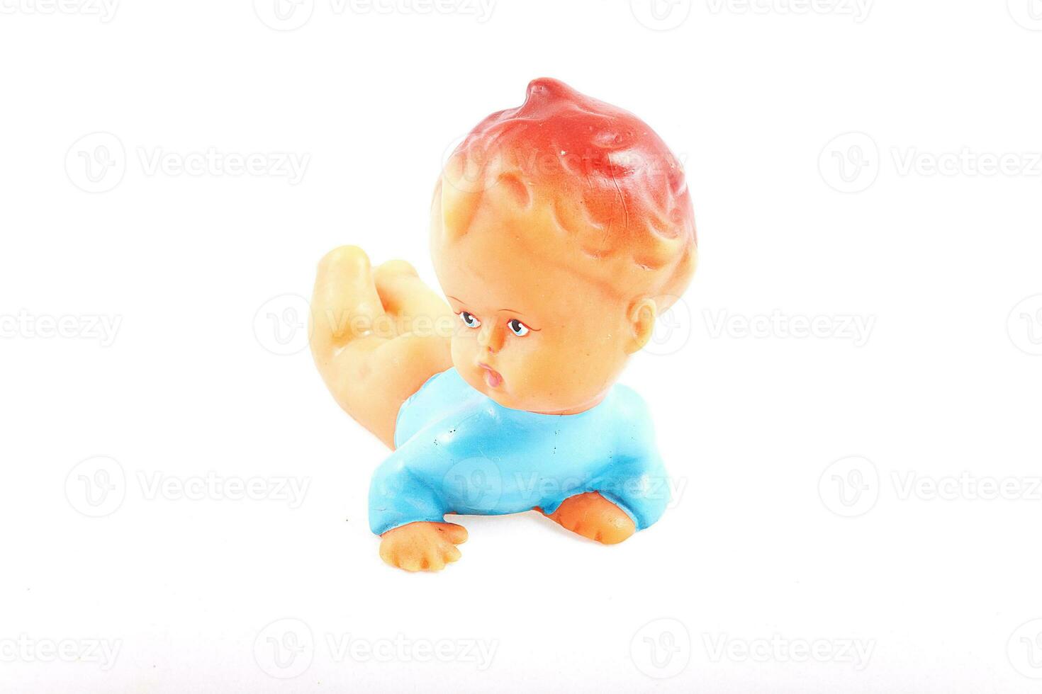 old, retro plastic squeaky toy for a small child on a white background photo