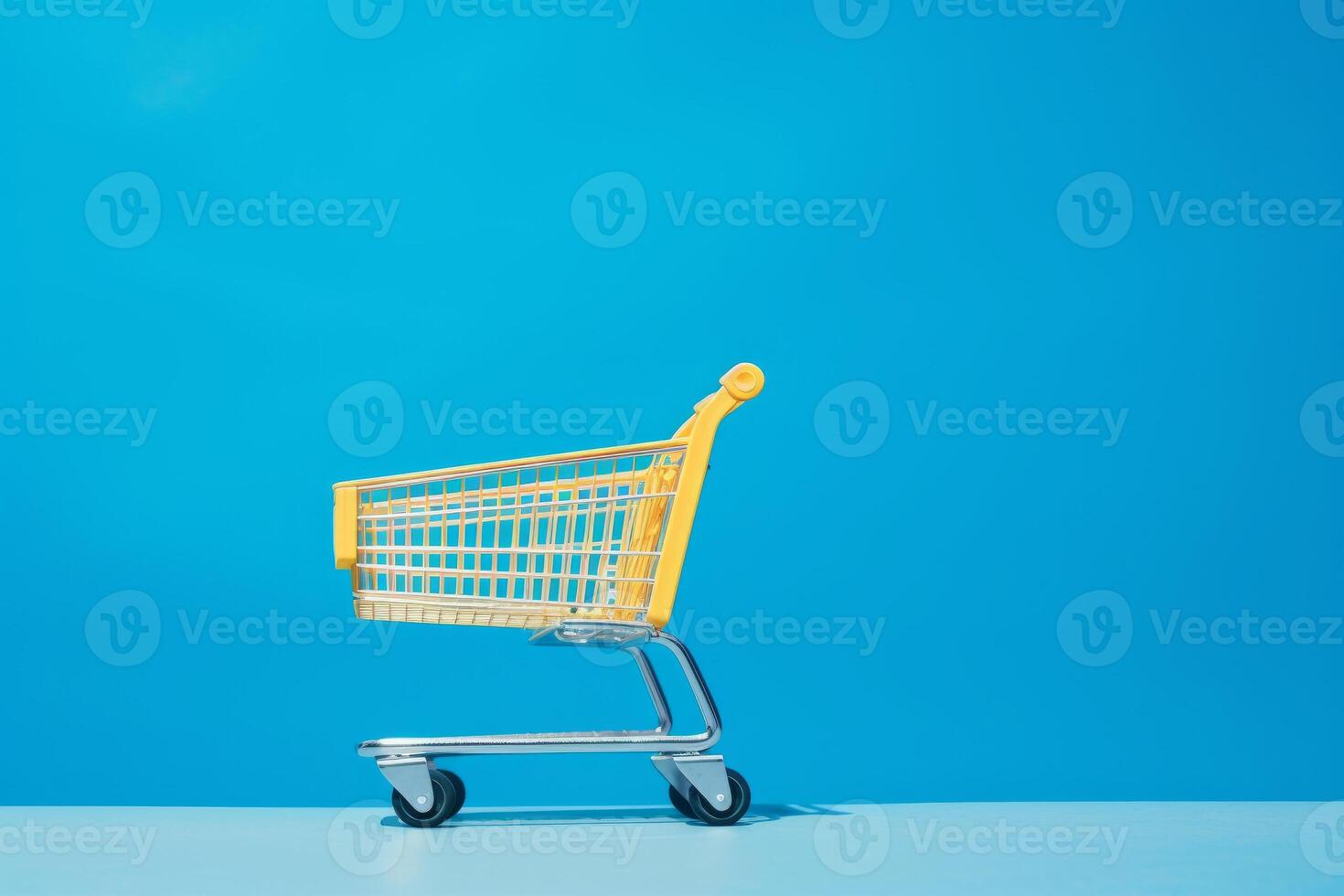 yellow shopping cart on blue background. photo