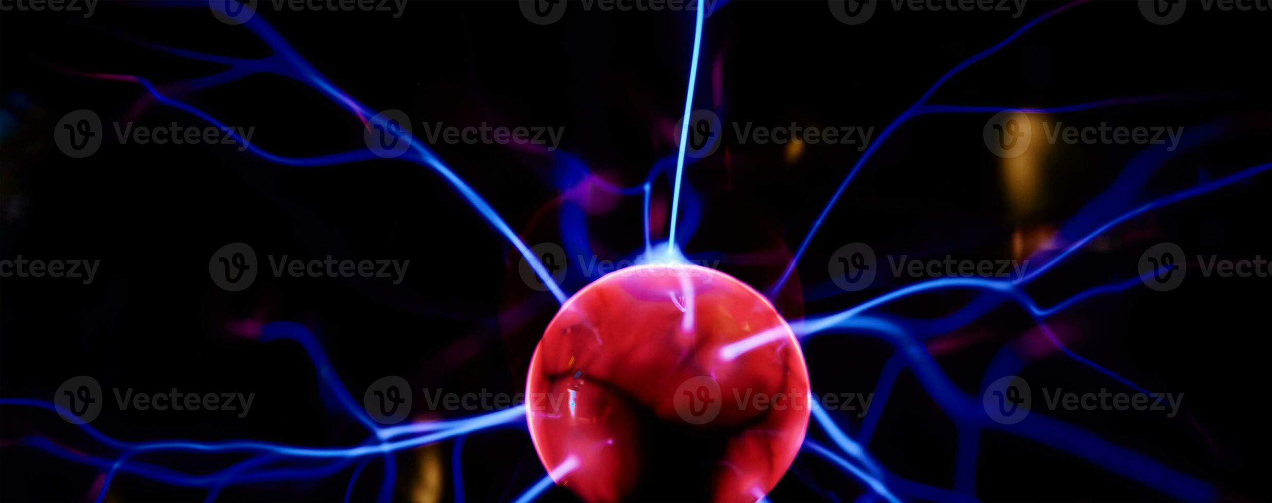 Plasma ball with energy rays on dark background photo