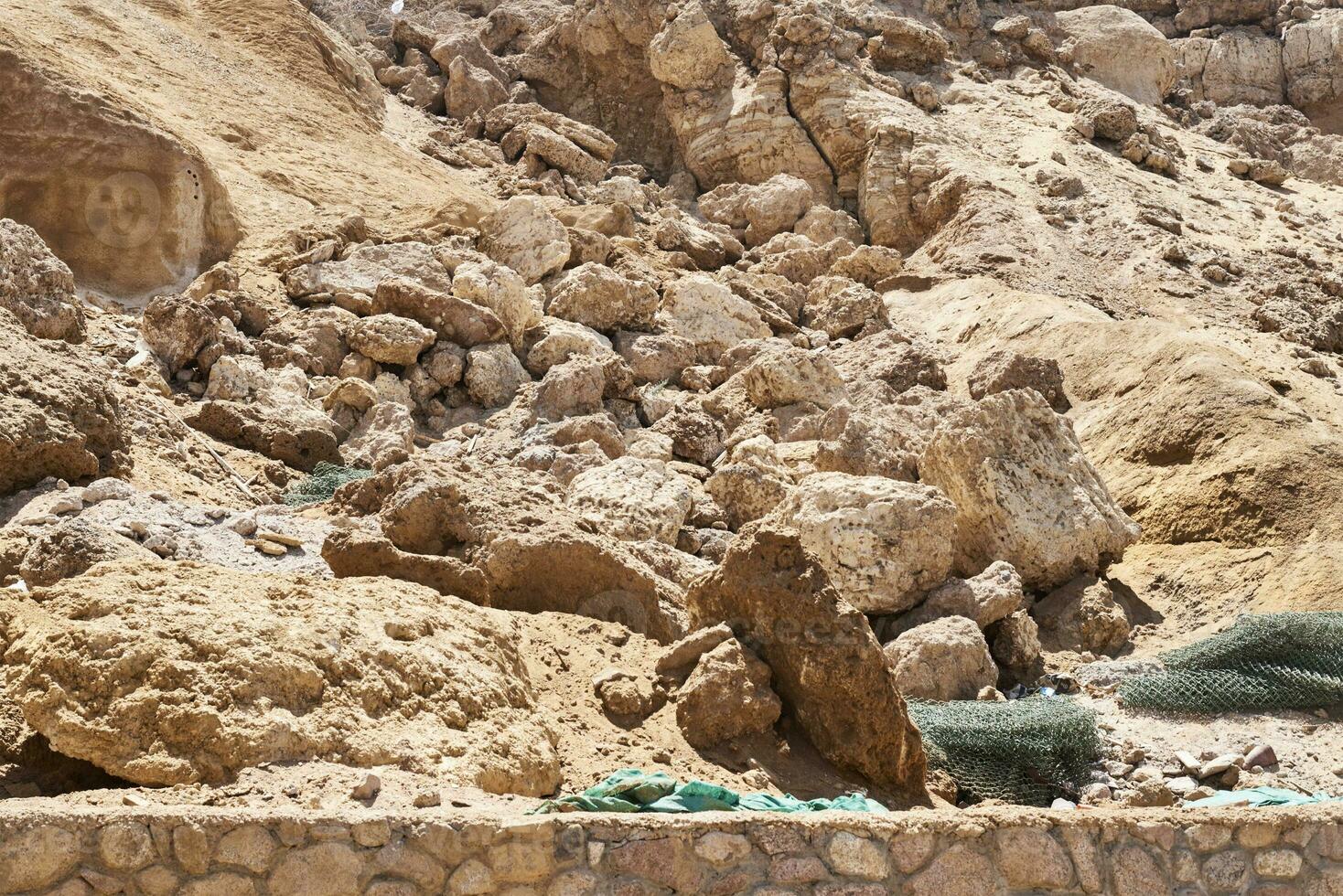 Rock collapse on the beach. Collapsed rock, blocked on visiting the beach by tourists photo