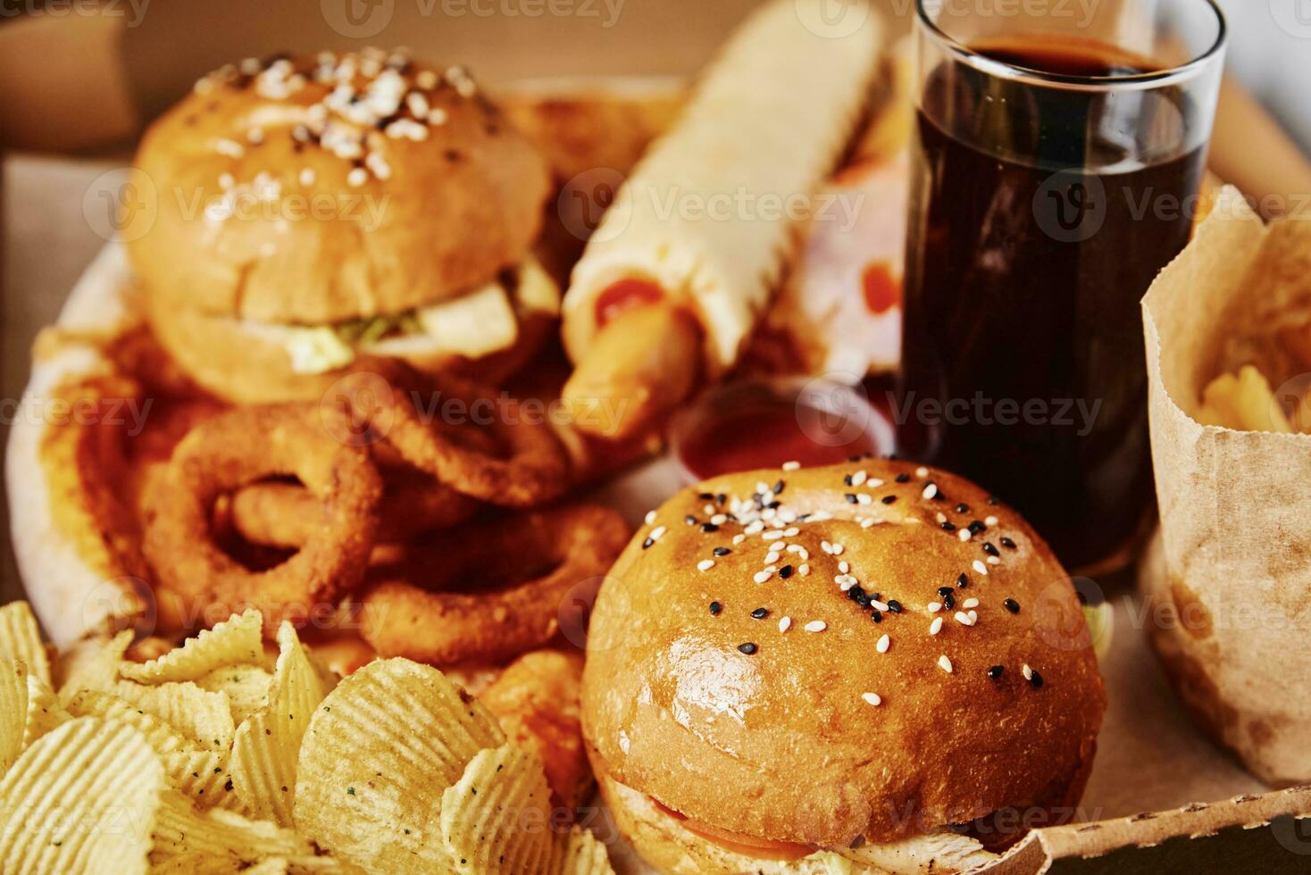 Unhealthy and junk food. Different types of fast food on the table, closeup photo