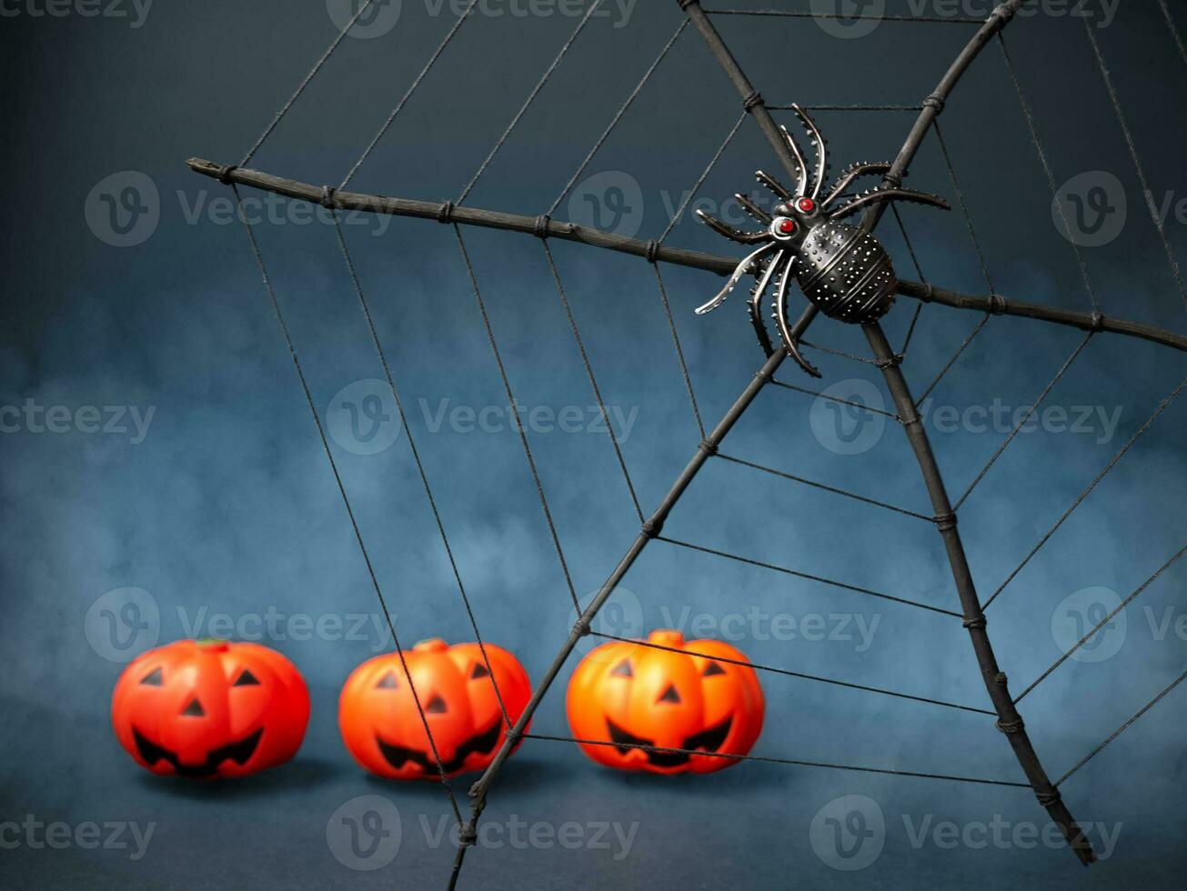 Halloween. Creepy spider on the web and Jack pumpkins. Selected sharpness. Scary night scene photo