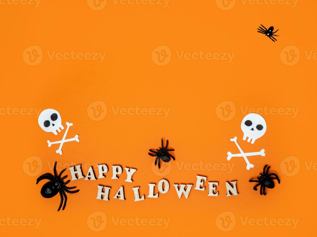 Halloween decorations on an orange background with the inscription happy Halloween and spiders. Flat layout, copy space photo