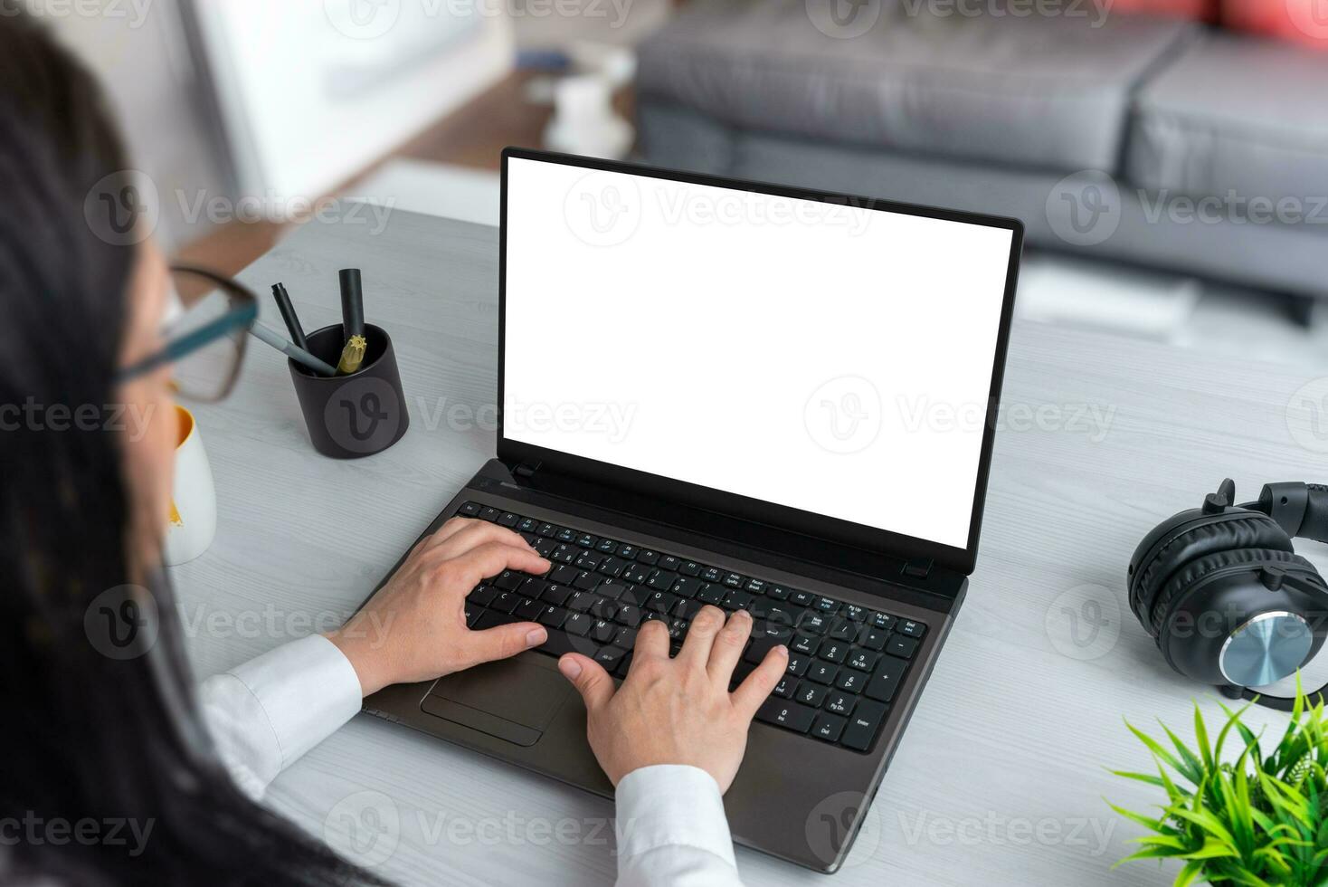 Woman work at home on laptop computer with isolated screen for web page presentation. Isolated screen in white. Living room in background photo