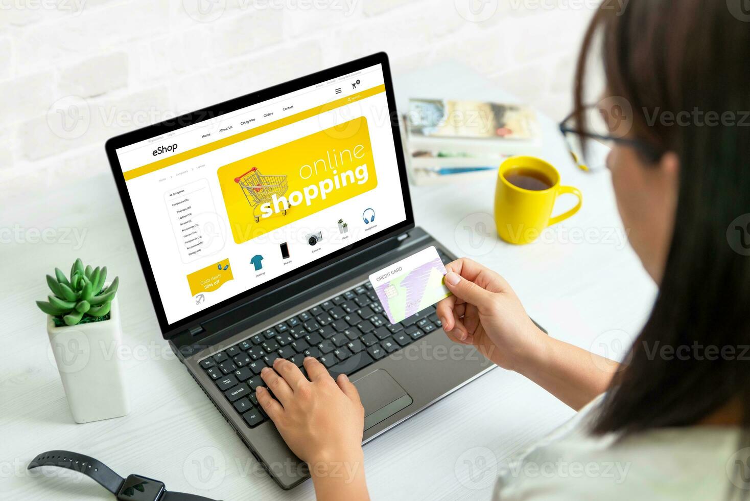 Woman use credit card to shopping online with laptop on ecommerce web site photo