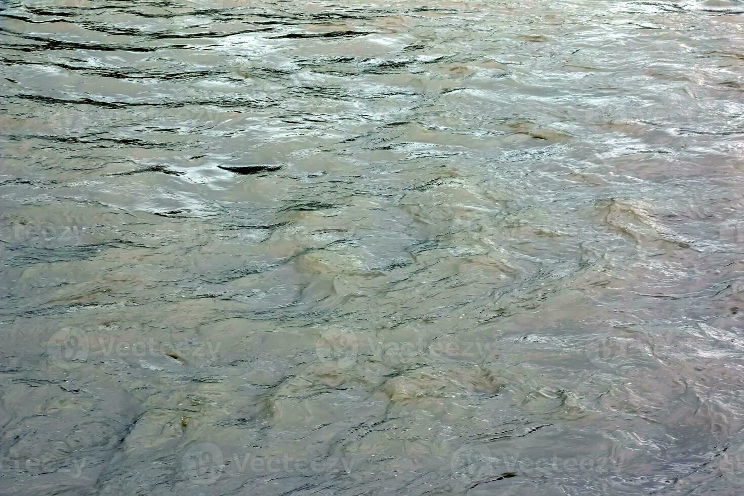 The texture of the water of the river. Natural water background with ripples and waves. photo