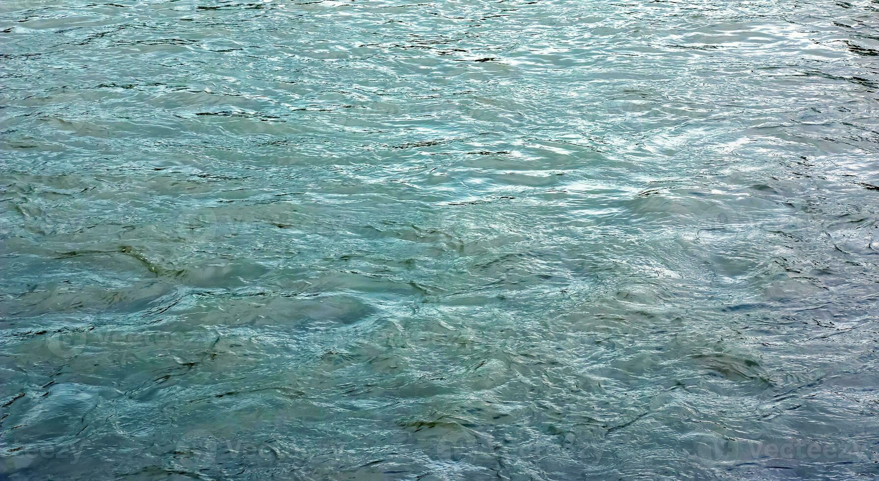 The texture of the water of the river. Natural water background with ripples and waves. photo