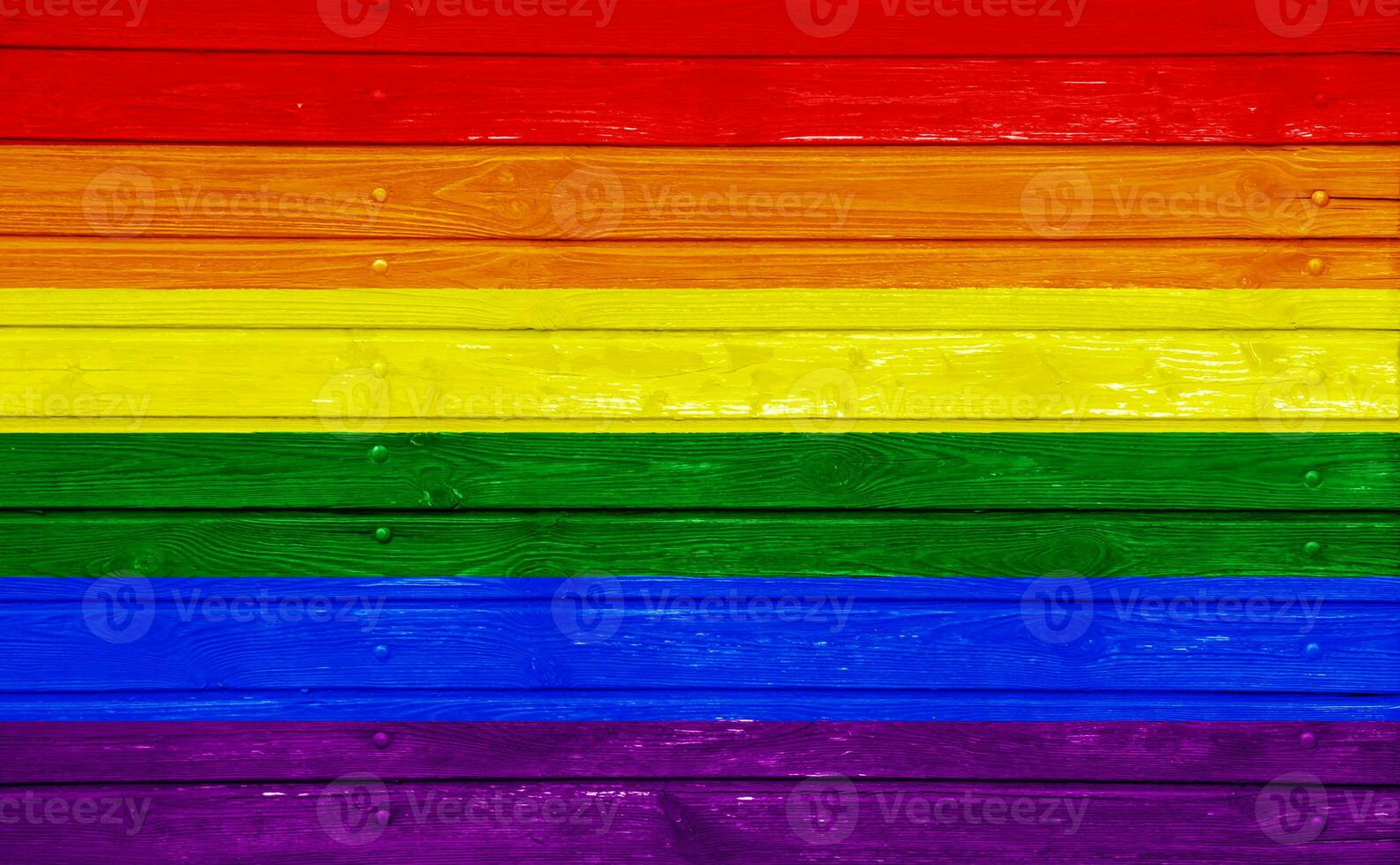 Flag of the LGBT community on the background of the wooden texture of the boards. Rainbow gay culture symbol. Concept collage. photo