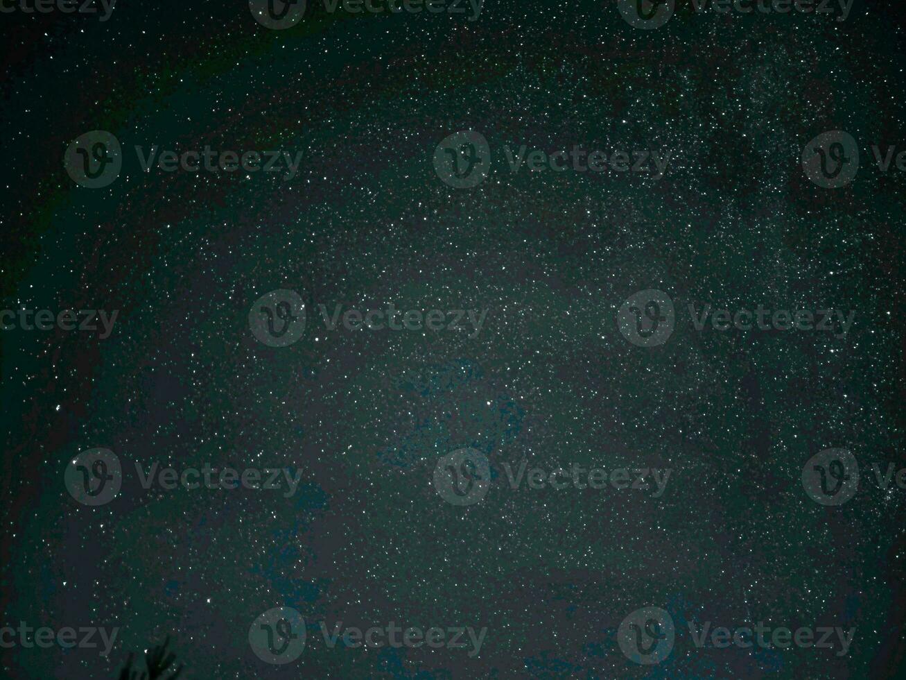 Astrophoto taken with the Galaxy S23 Ultra. The starry sky and the Milky Way galaxy are visible in the countryside at night. photo