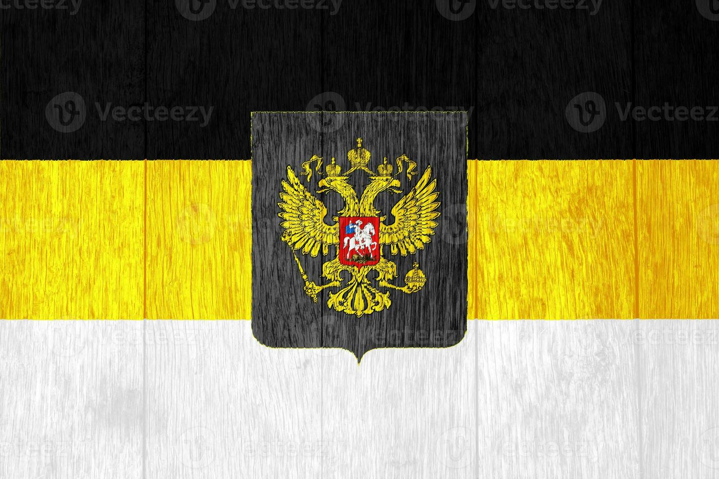 Russian imperial flag with a double-headed eagle. The first official State flag of the Russian Empire and the Flag for celebrations on the texture. Concept collage. photo