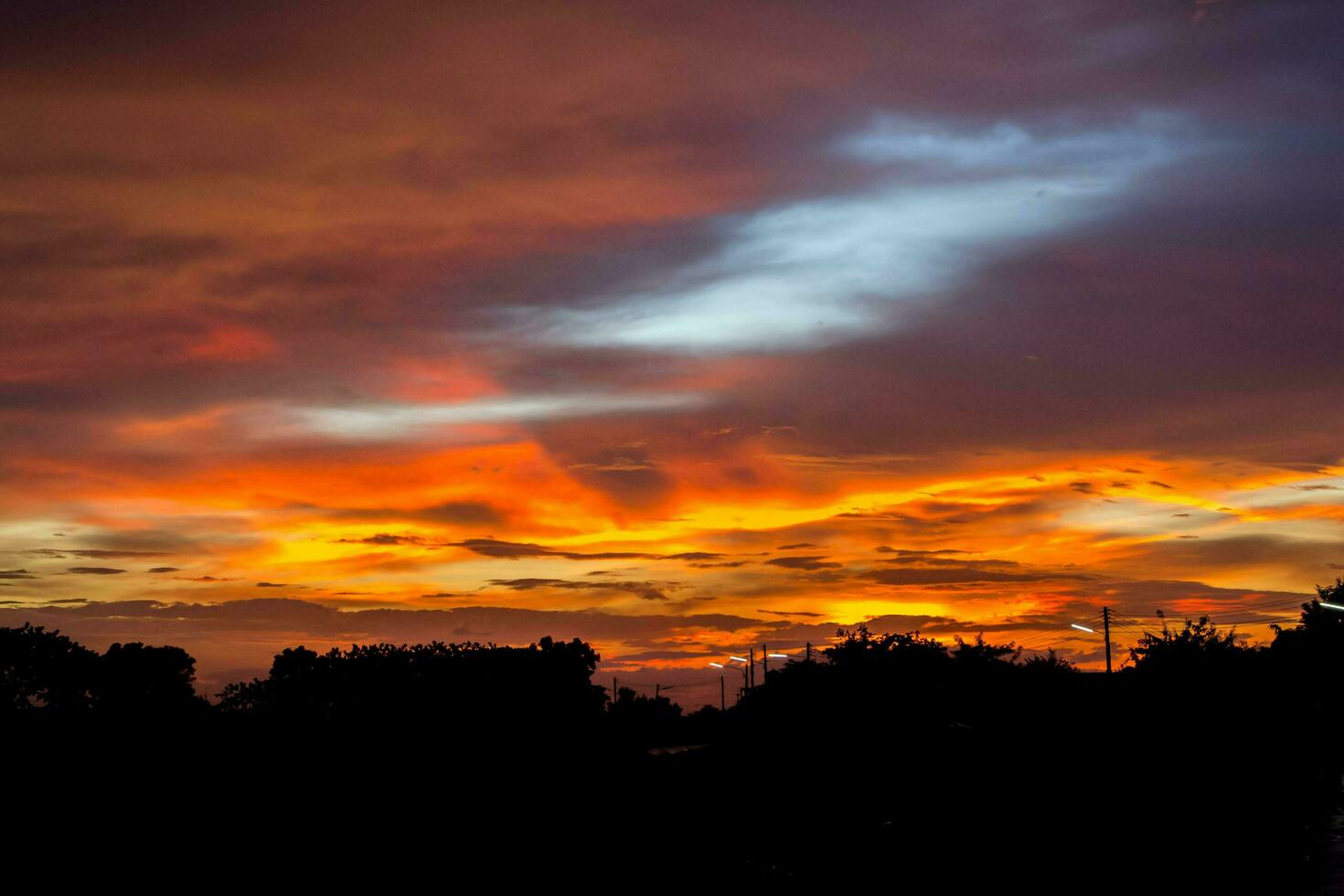 colorful red, blue, and yellow sky in the evening in a rural area in Thailand, when the sun has set, is a panoramic view of the warmth. Hot, hot and scary photo