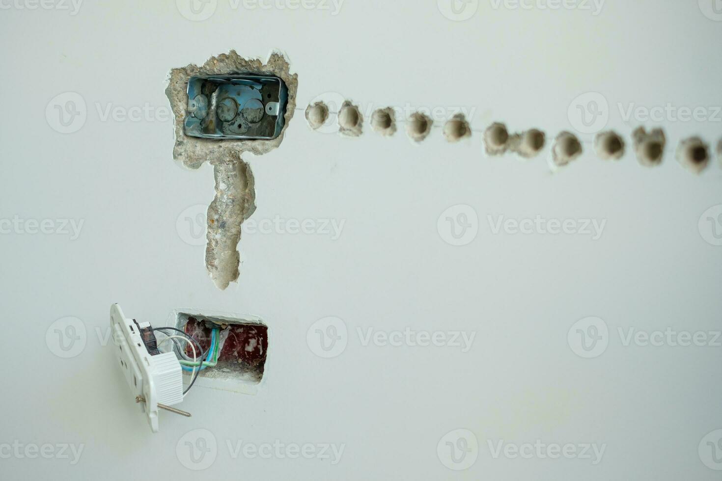 Electrical Wiring under plaster, hidden installation cables for socket to a concrete. Renovation, Repair and development of home and apartment concepts photo