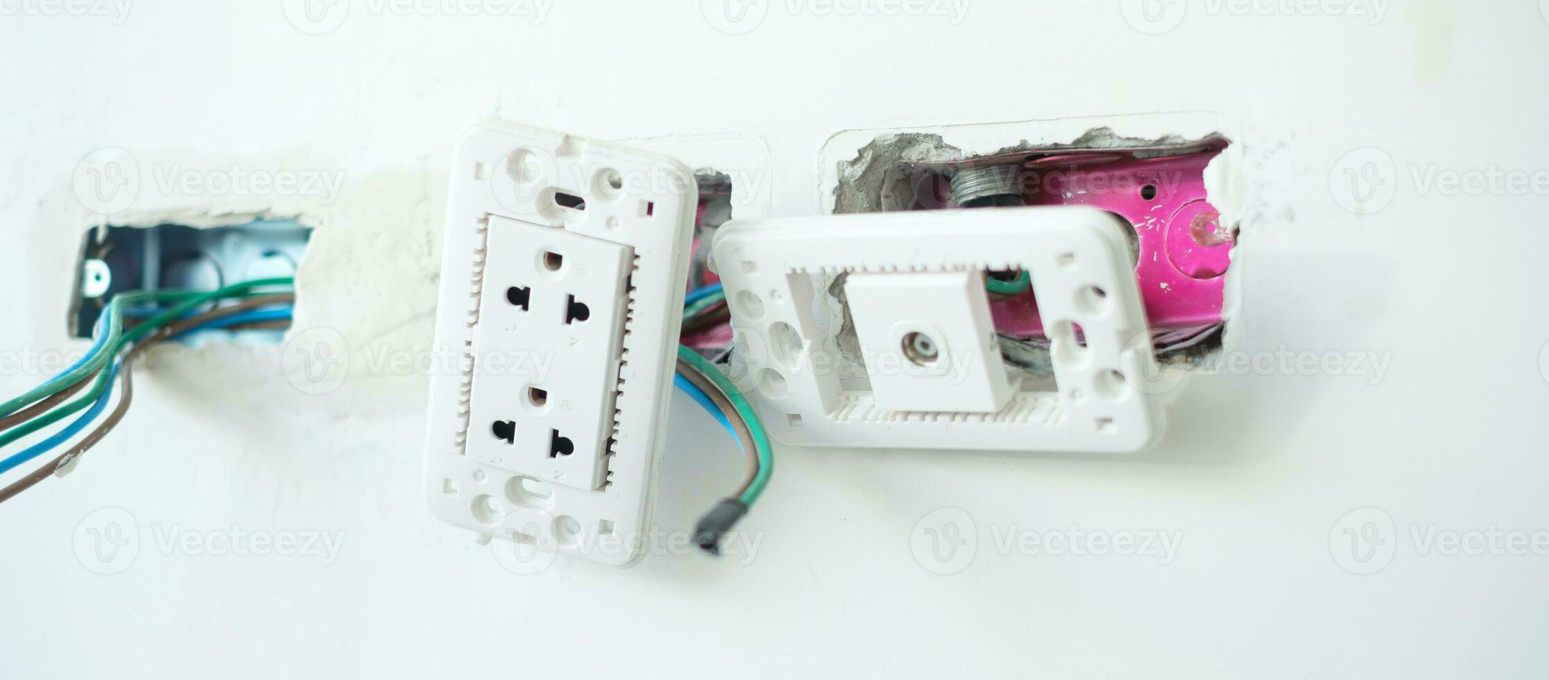 Electrical Wiring under plaster, hidden installation cables for socket to a concrete. Renovation, Repair and development of home and apartment concepts photo