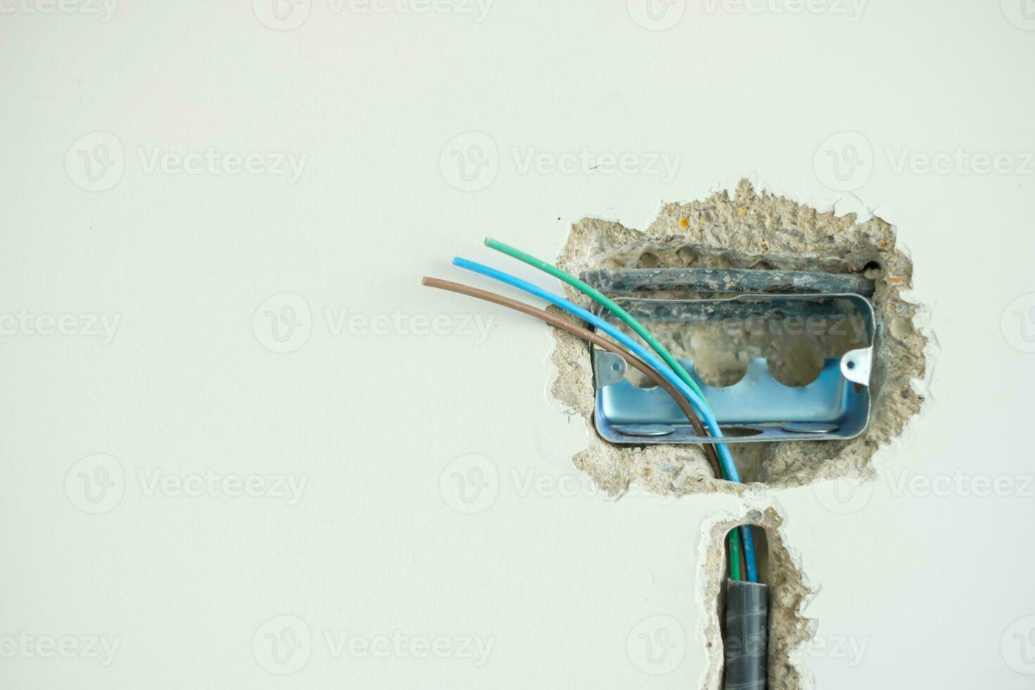 Electrical Wiring under plaster, hidden installation cables for socket to a concrete. Renovation, Repair and development of home and apartment concepts photo