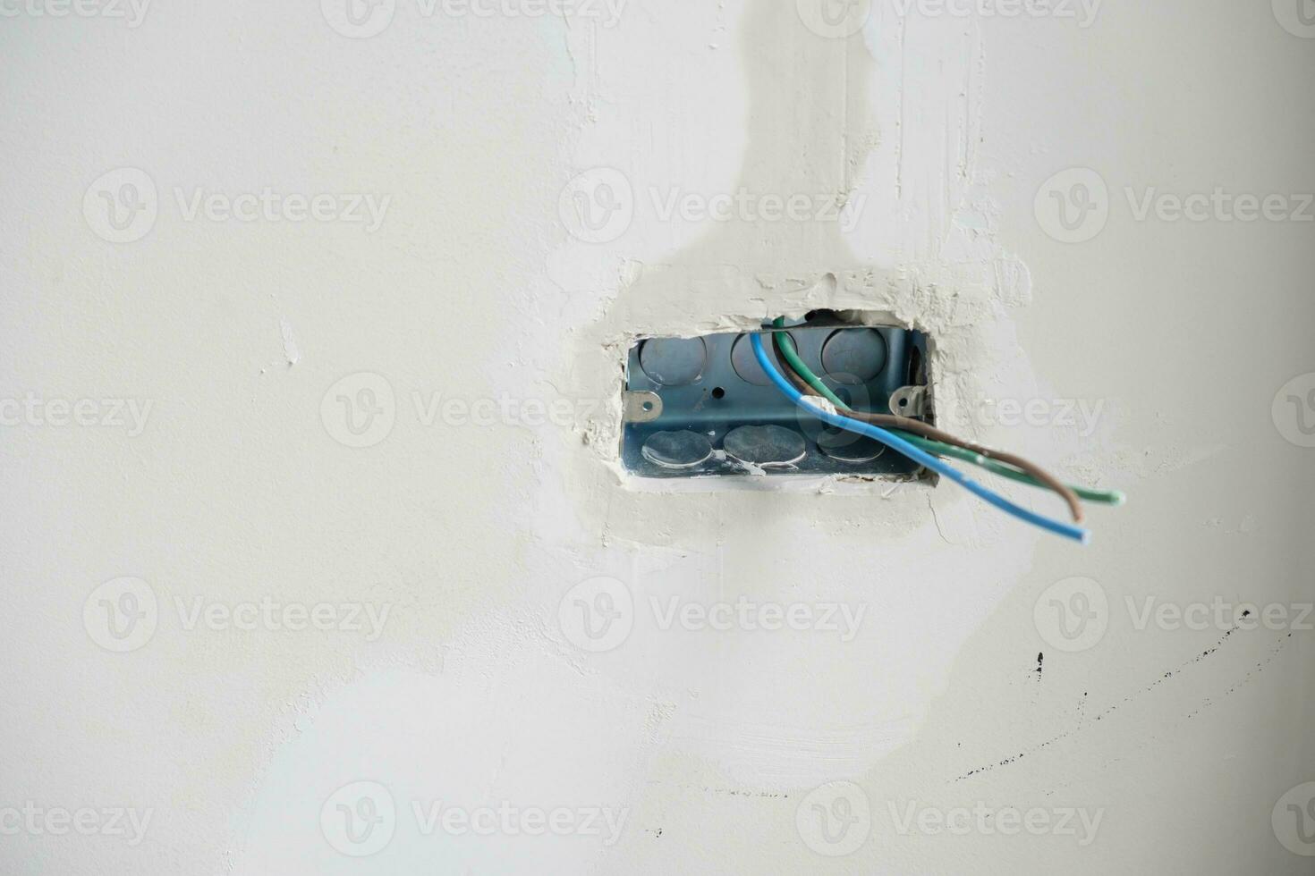 Electrical Wiring under plaster, hidden installation cables for socket to a concrete. Renovation, Repair and development of home and apartment concepts photo