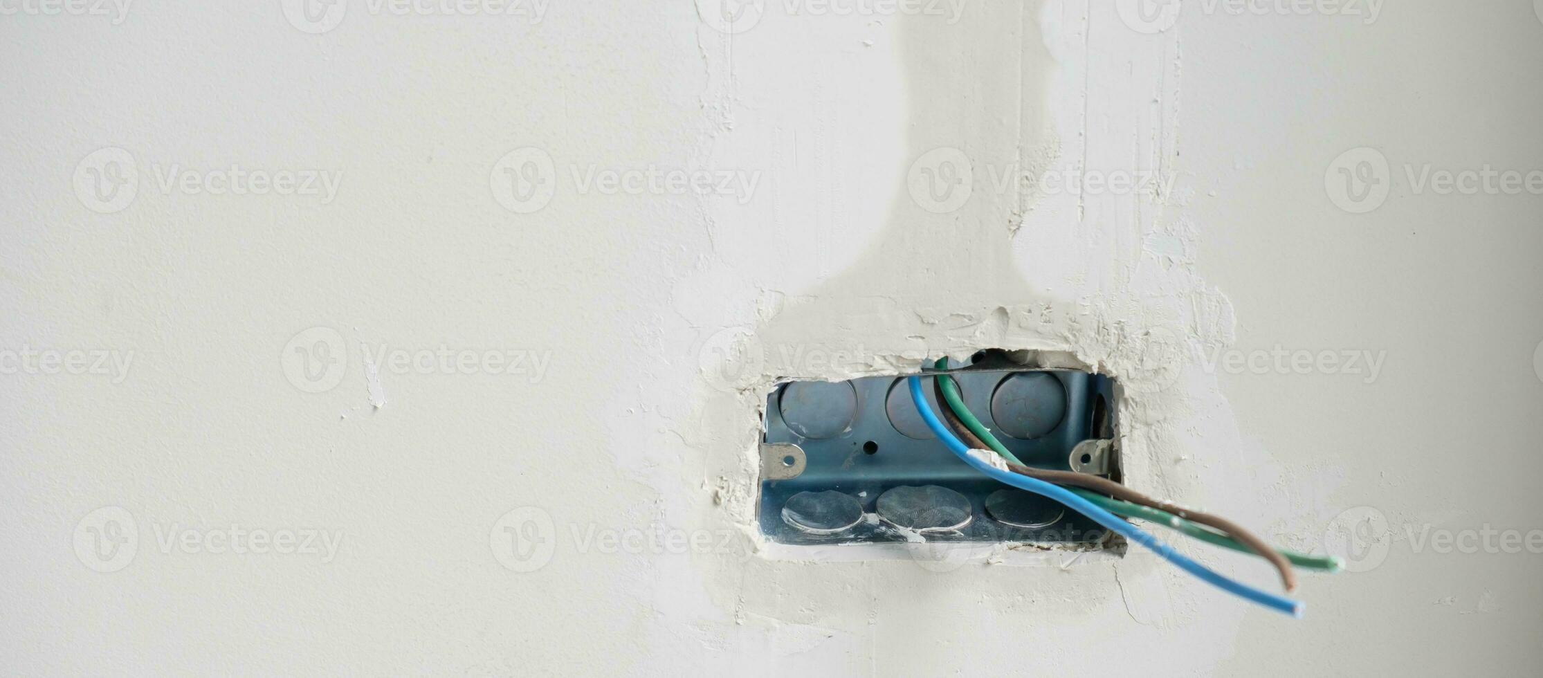 Electrical Wiring under plaster, hidden installation cables for socket to a concrete. Renovation, Repair and development of home and apartment concepts photo