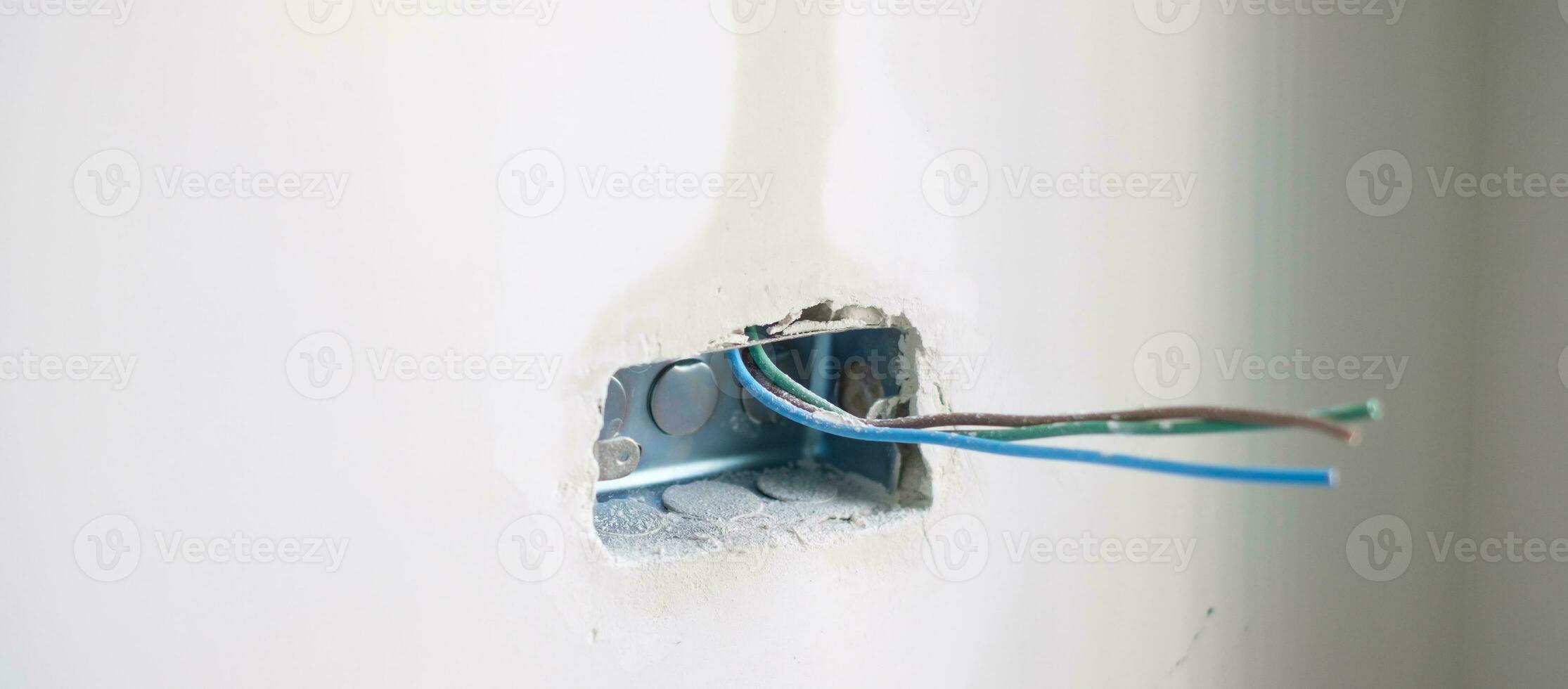 Electrical Wiring under plaster, hidden installation cables for socket to a concrete. Renovation, Repair and development of home and apartment concepts photo