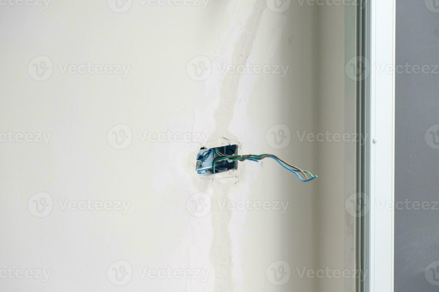 Electrical Wiring under plaster, hidden installation cables for socket to a concrete. Renovation, Repair and development of home and apartment concepts photo